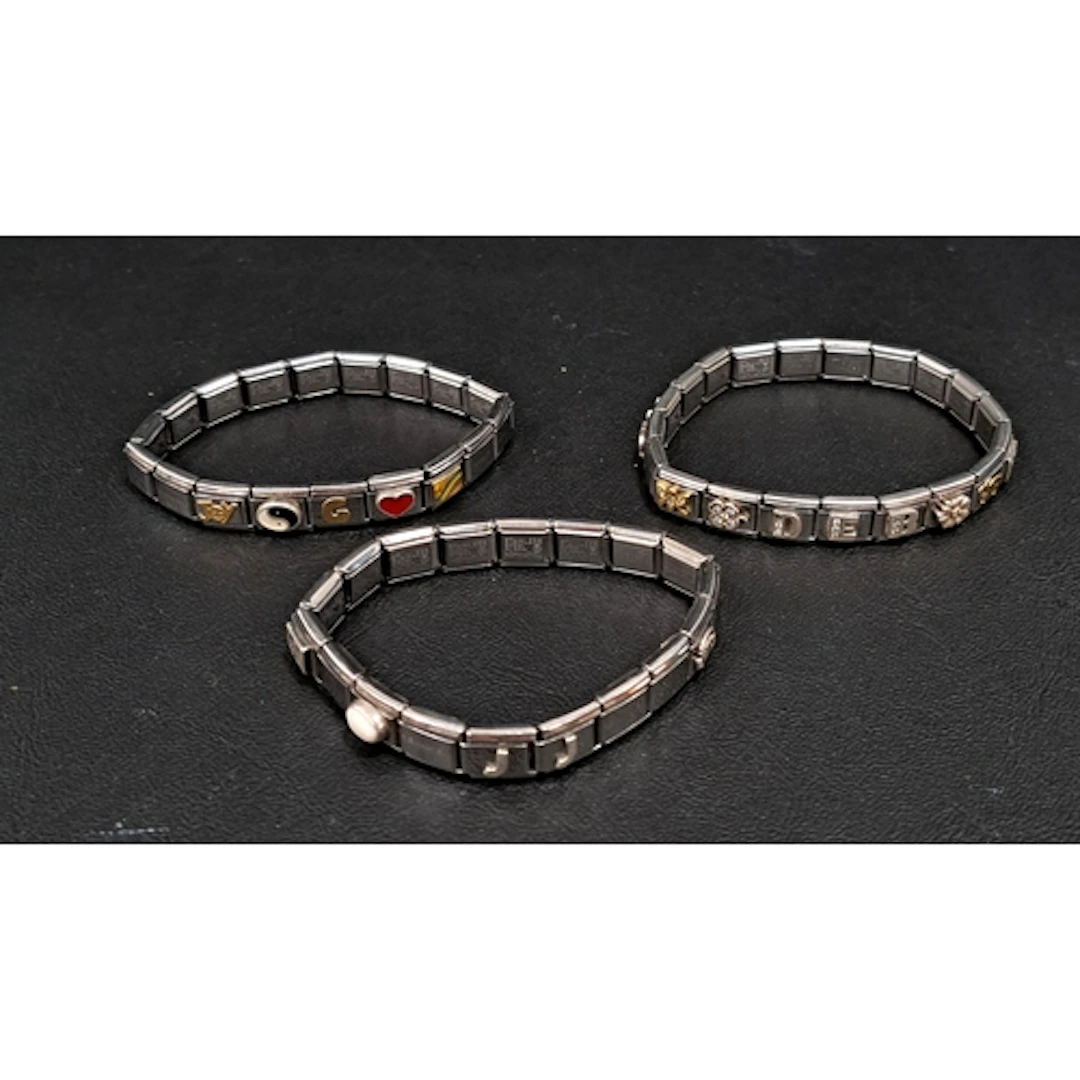 THREE NOMINATION CHARM BRACELETS with a total of 31 charms