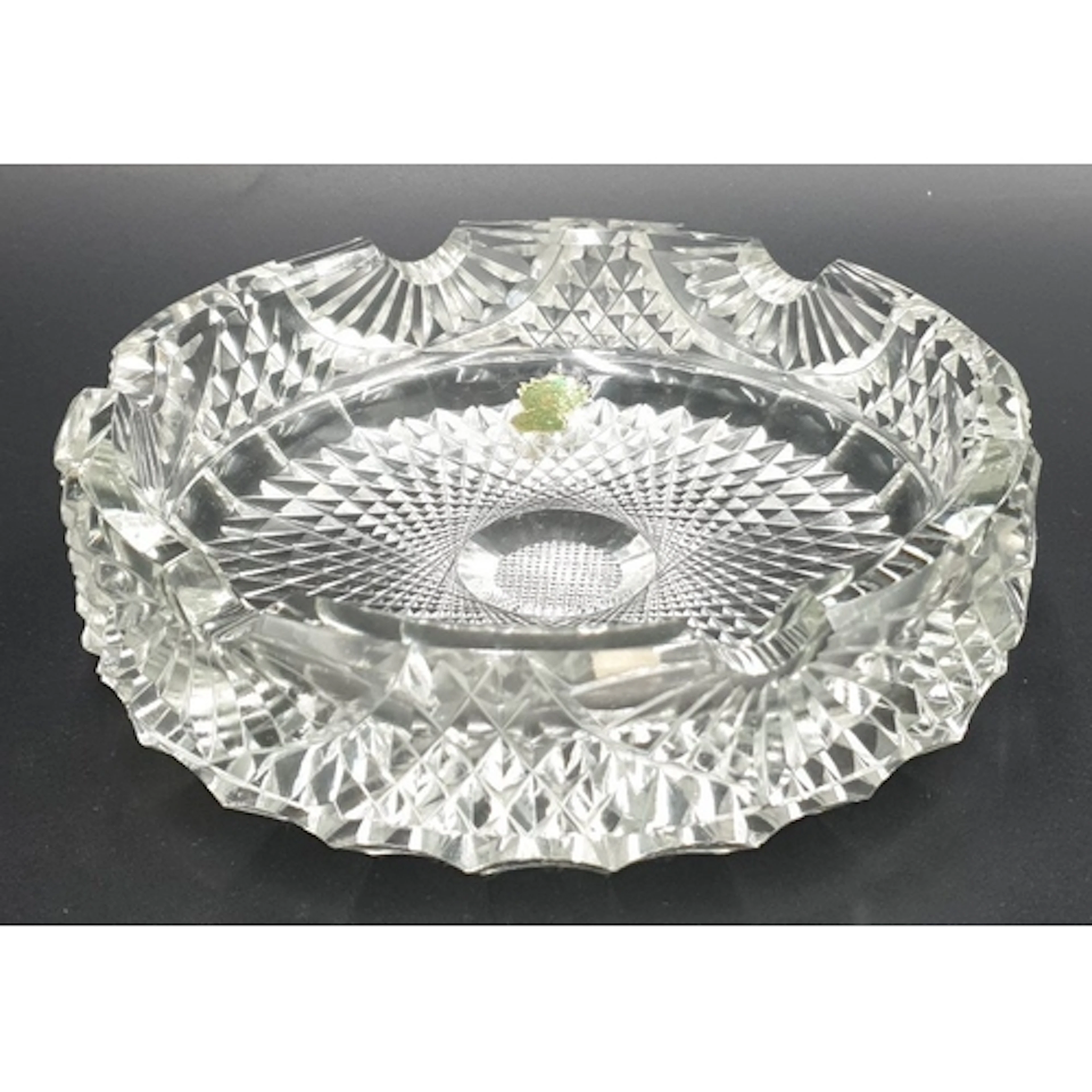 Waterford Crystal ashtray with scalloped rim, retaining foil...