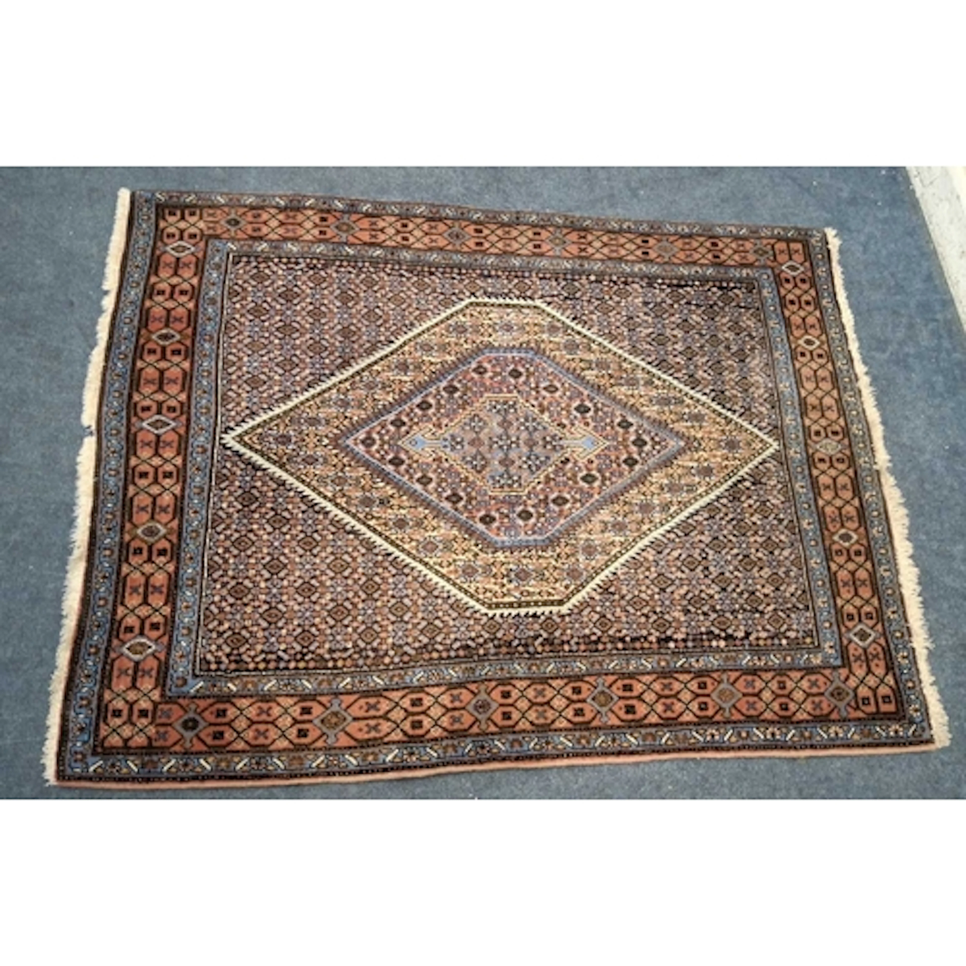 A MULTI-COLOURED RECTANGULAR BIDJAR PERSIAN RUG, with repeat...