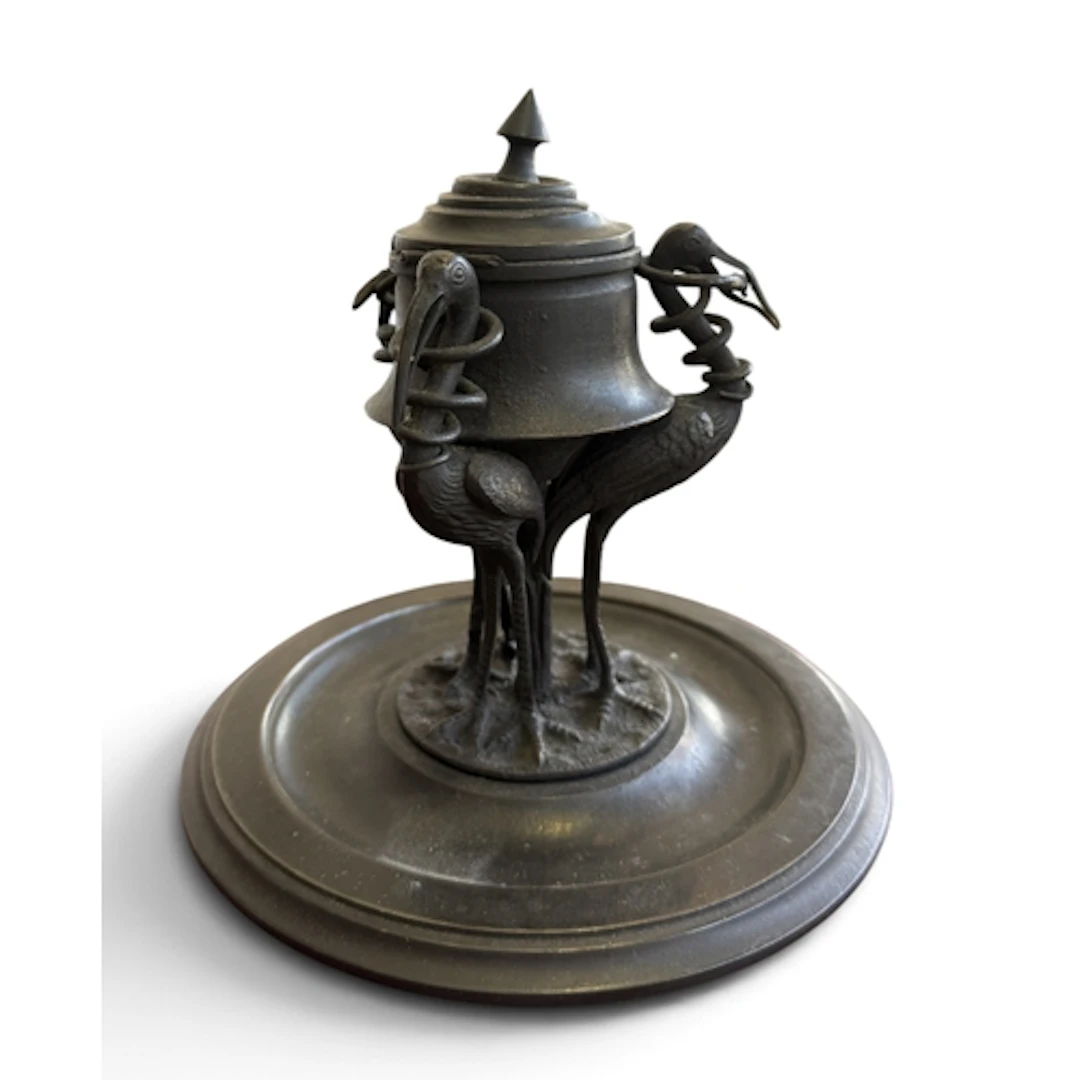 A BRONZED METAL INKWELL SUPPORTED WITH THREE STORKS On circu...
