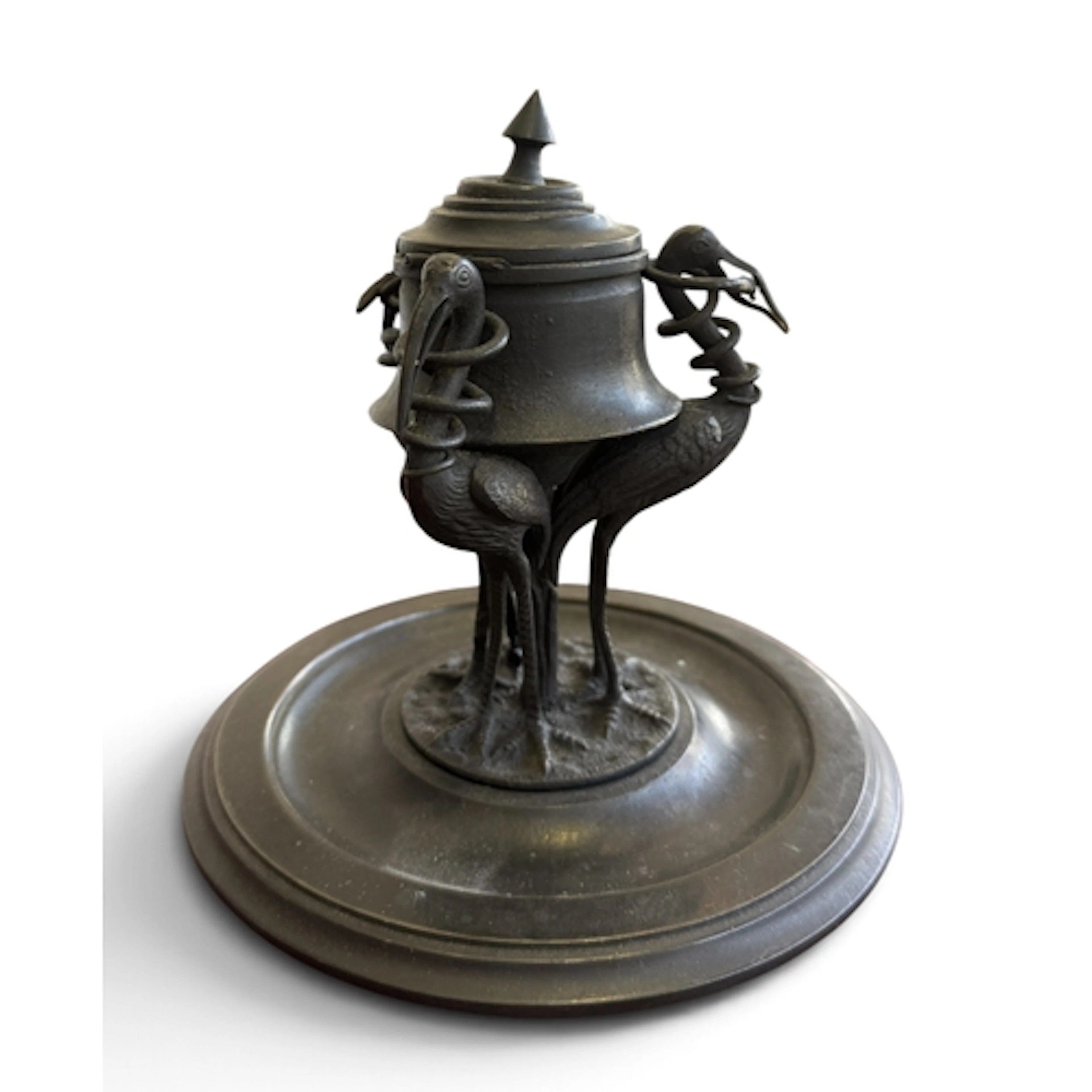 A BRONZED METAL INKWELL SUPPORTED WITH THREE STORKS On circu...