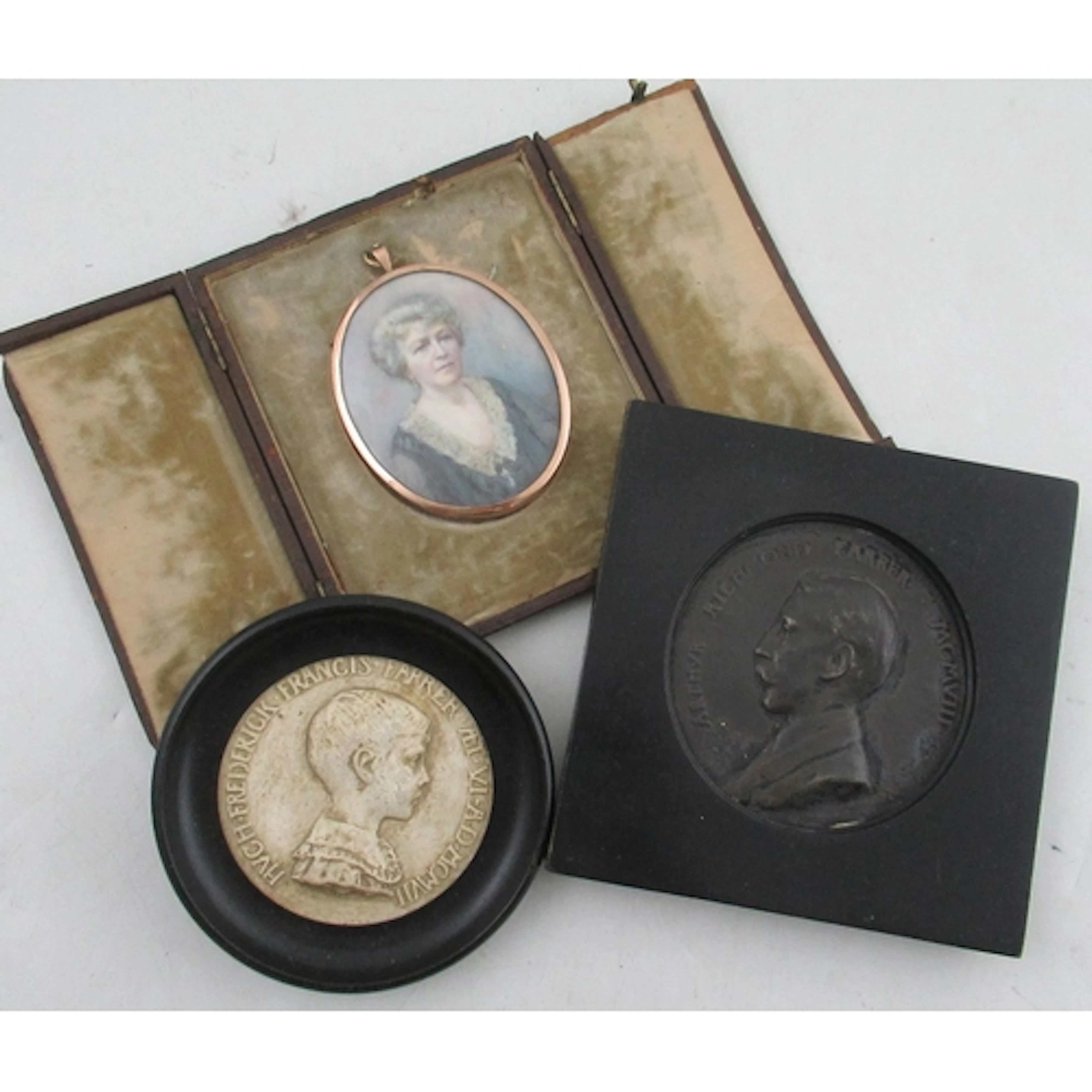 A 19th century oval portrait miniature, painted on ivory, of...
