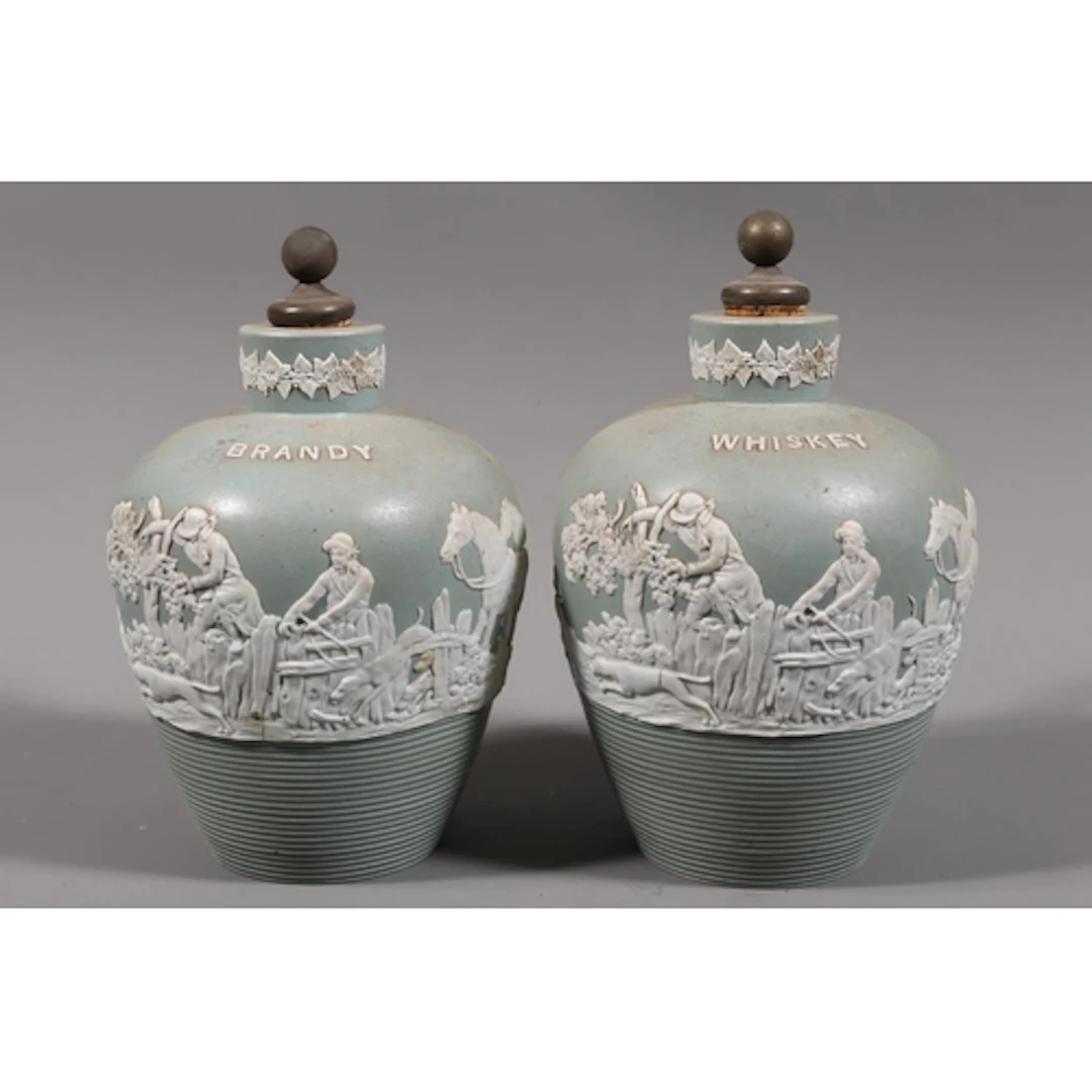 Pair of jasperware decanters, brandy and whisky, each decora...