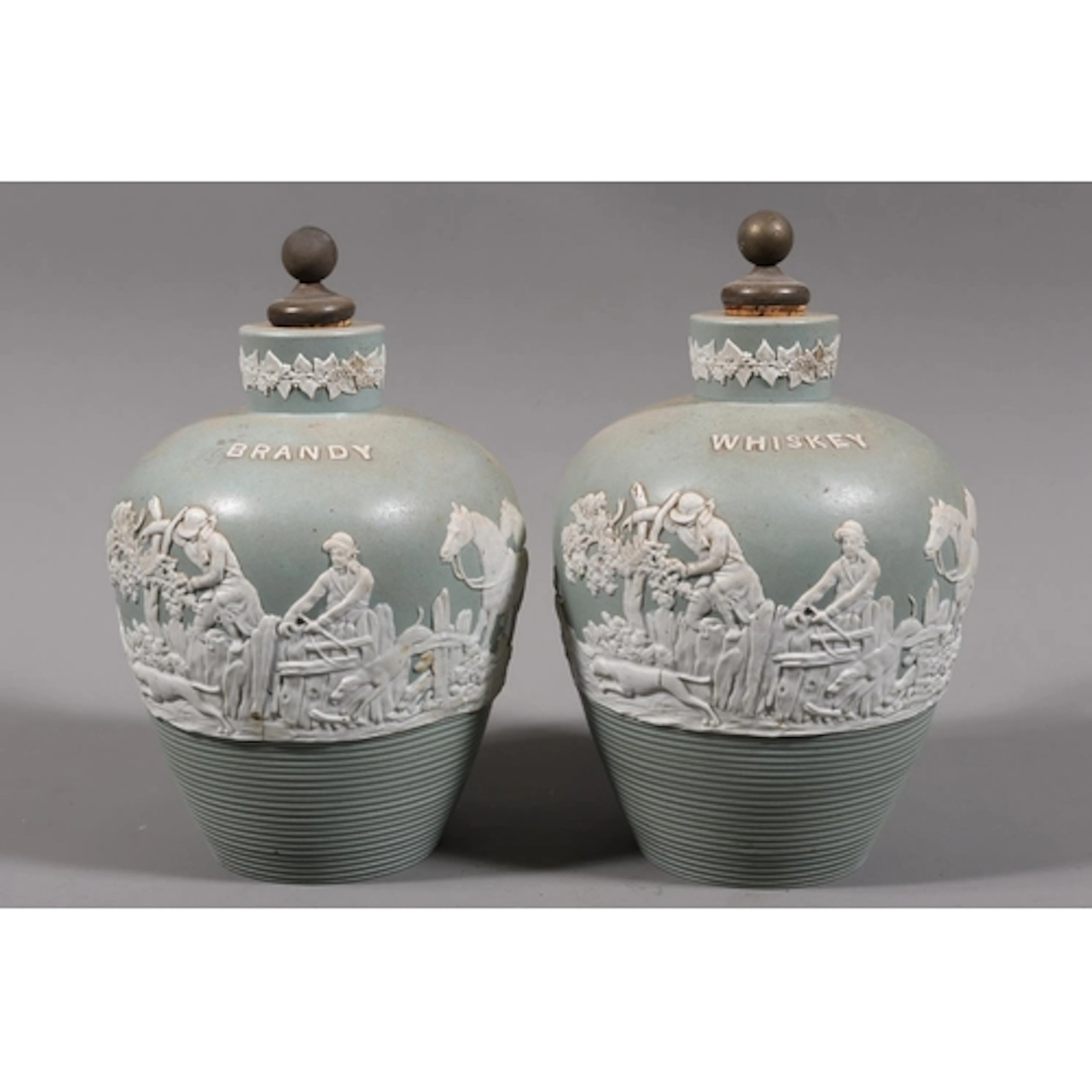Pair of jasperware decanters, brandy and whisky, each decora...