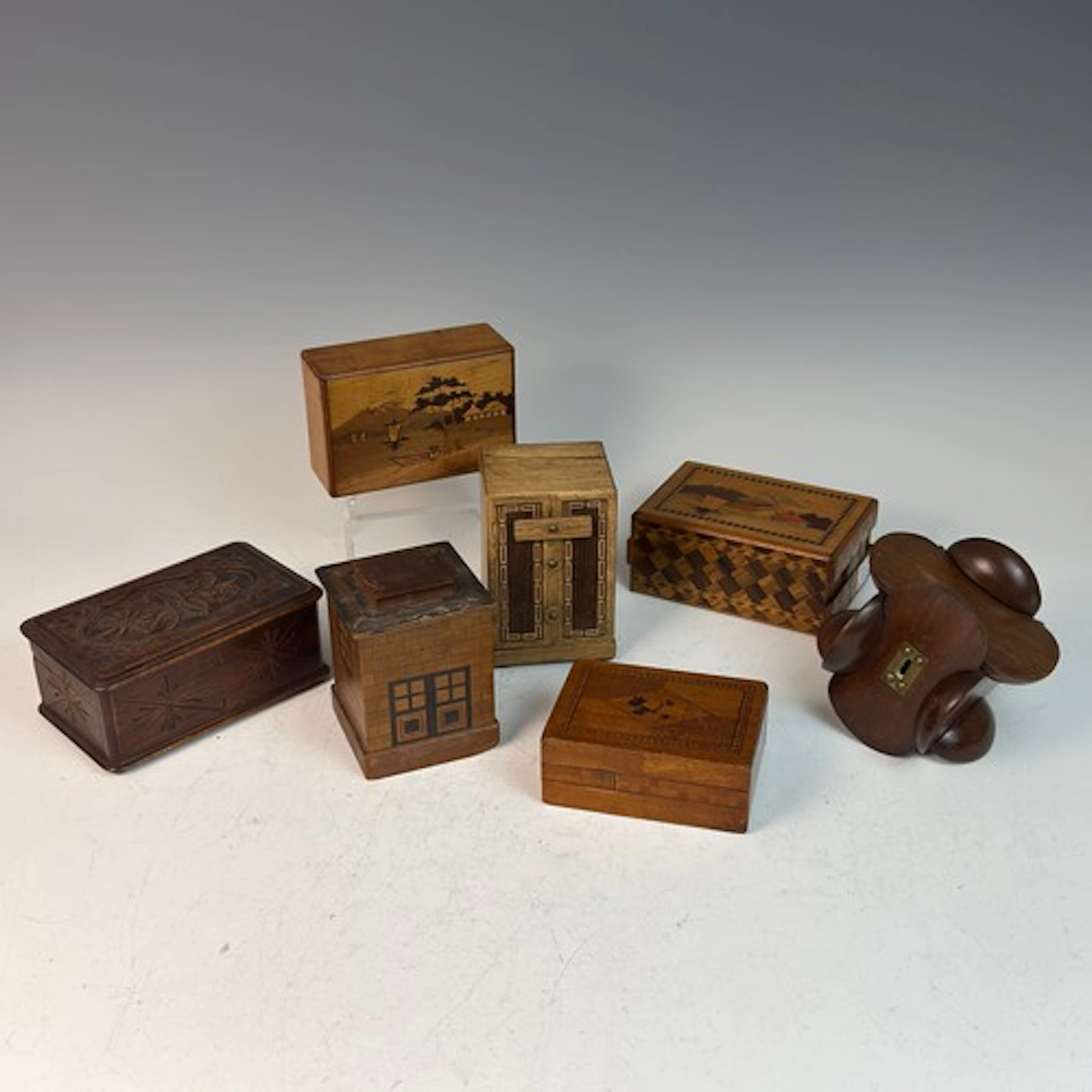 Seven novelty puzzle money Boxes, one in the form of a house...