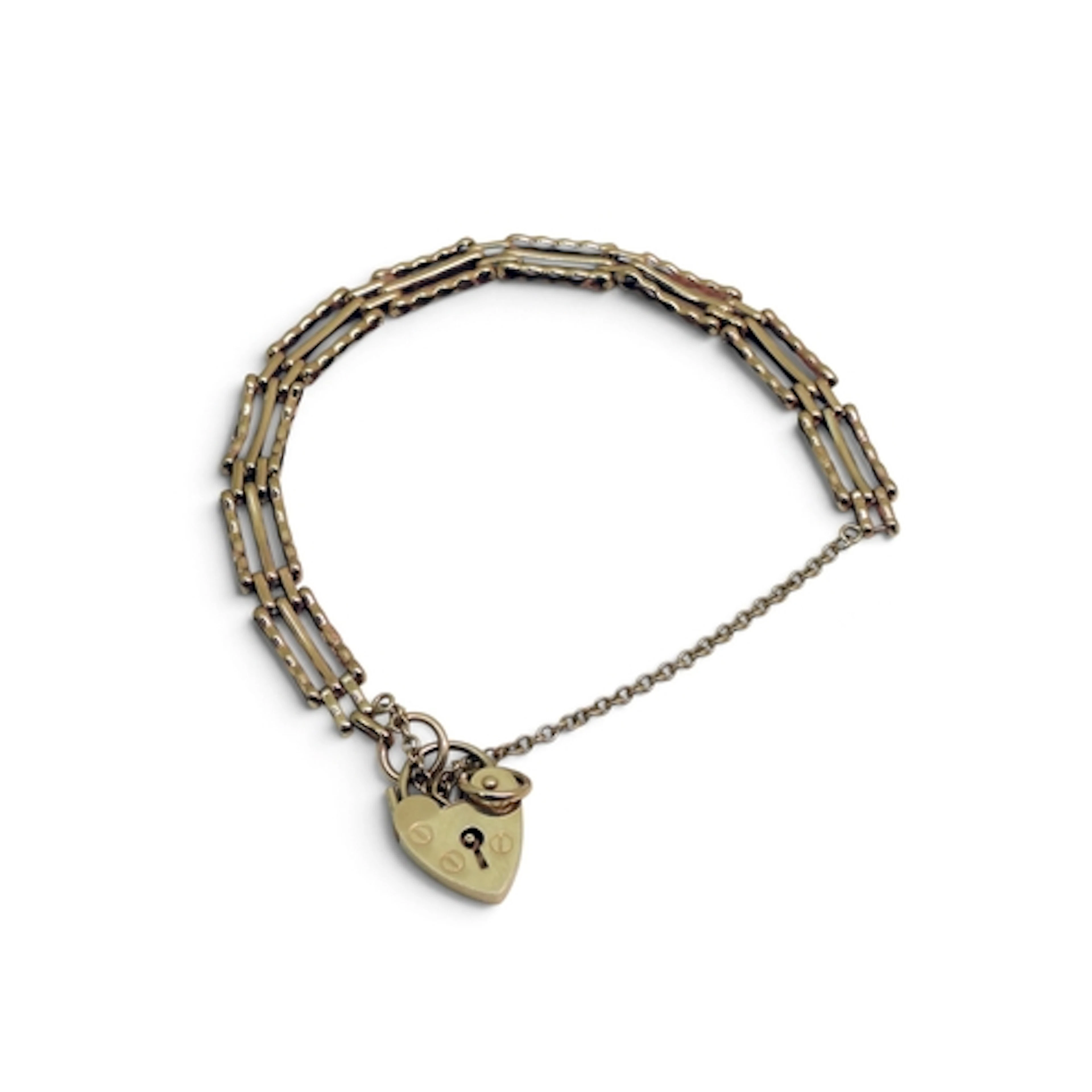 A 9ct gold gate bracelet with a heart shaped clasp, length 1...