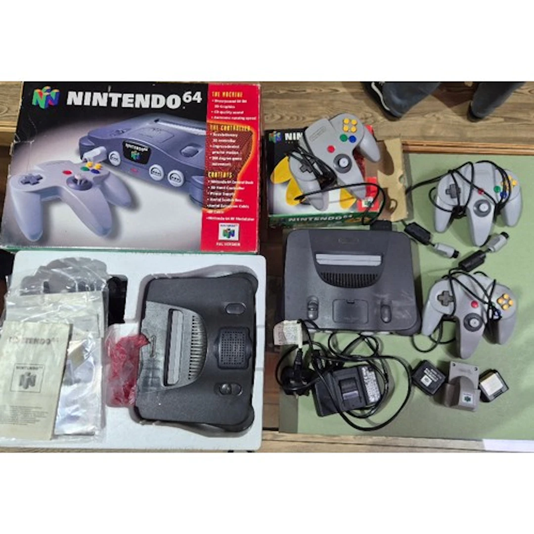 Two Nintendo 64 consoles with three controllers.