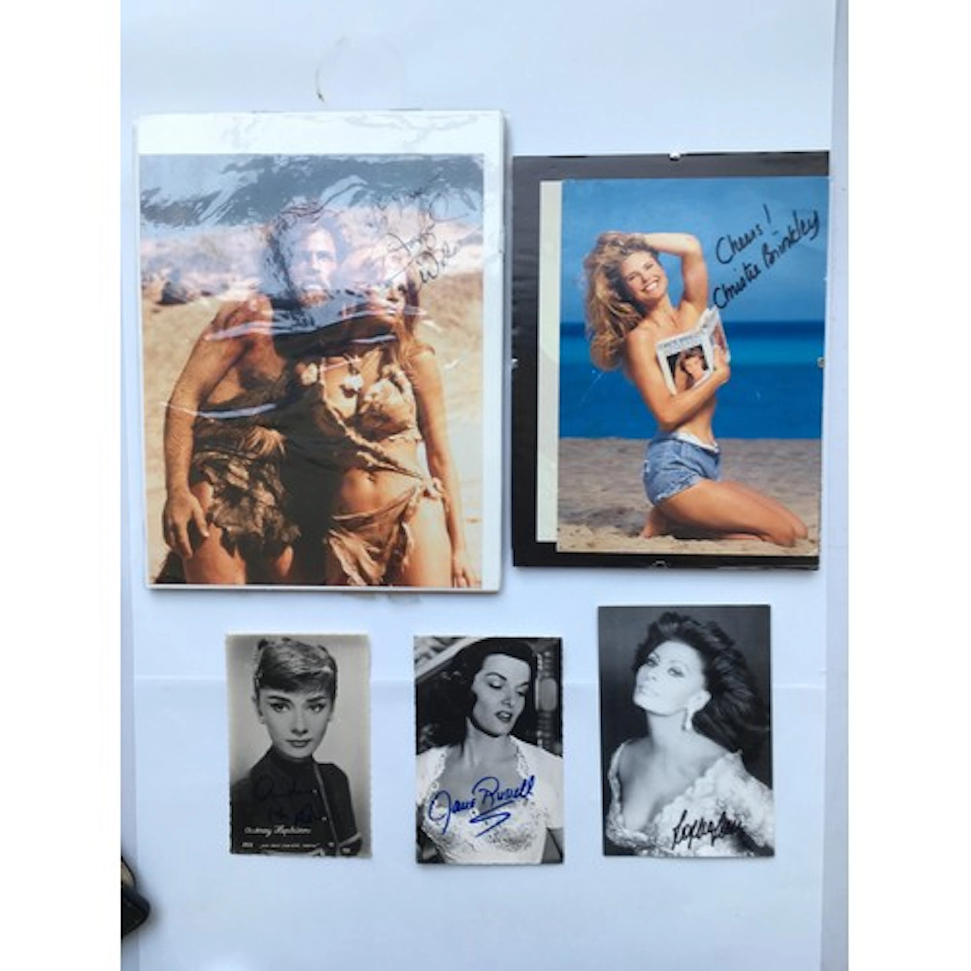 A small collection of autographs comprising Racquel Welsh, S...