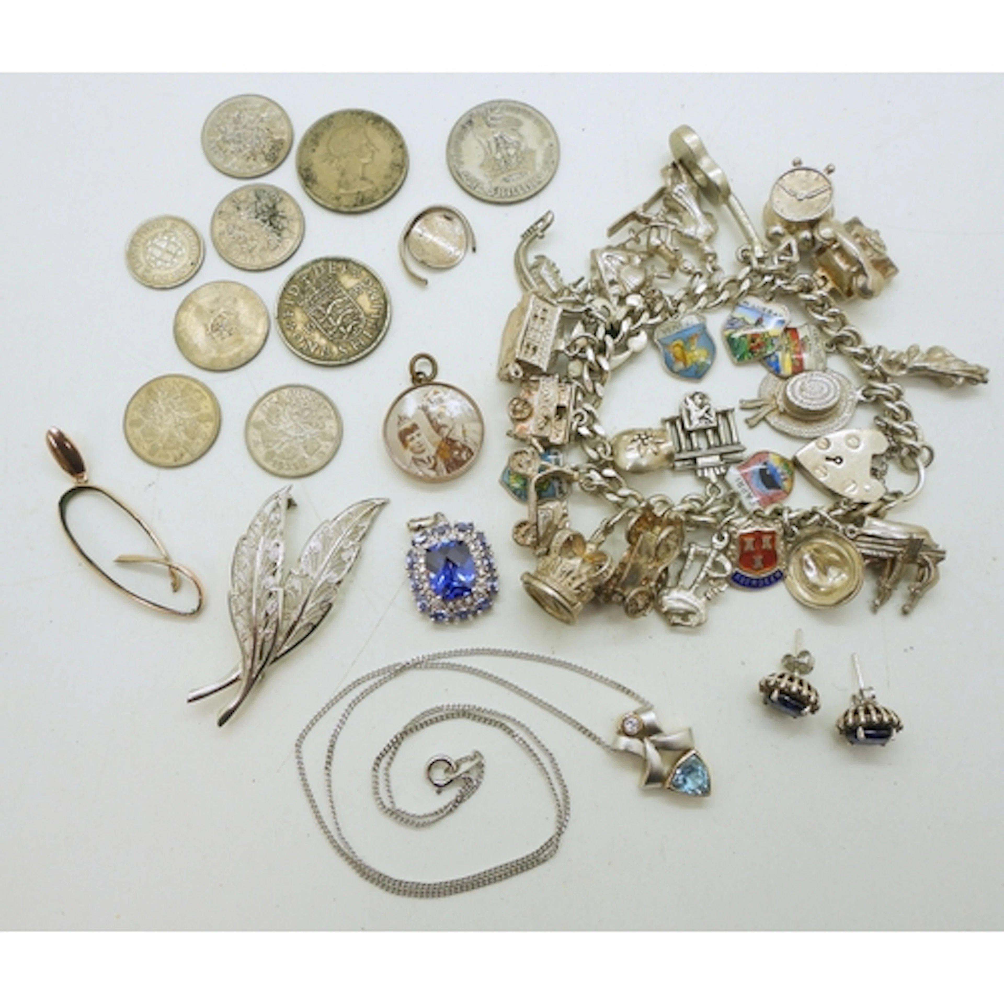 An extensive silver charm bracelet, with a collection of att...