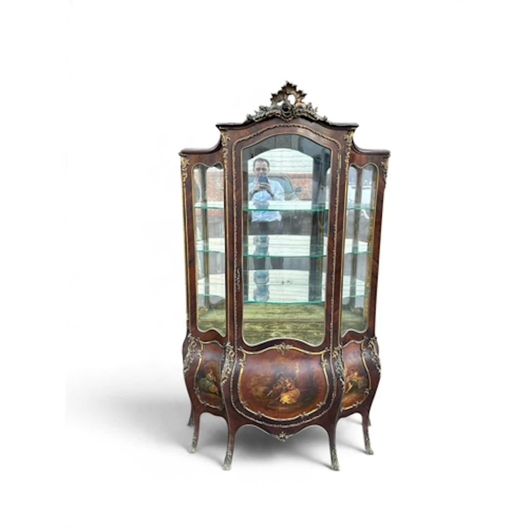 A 19TH CENTURY GLASS DISPLAY CABINET OF BOMBE FORM The lower...