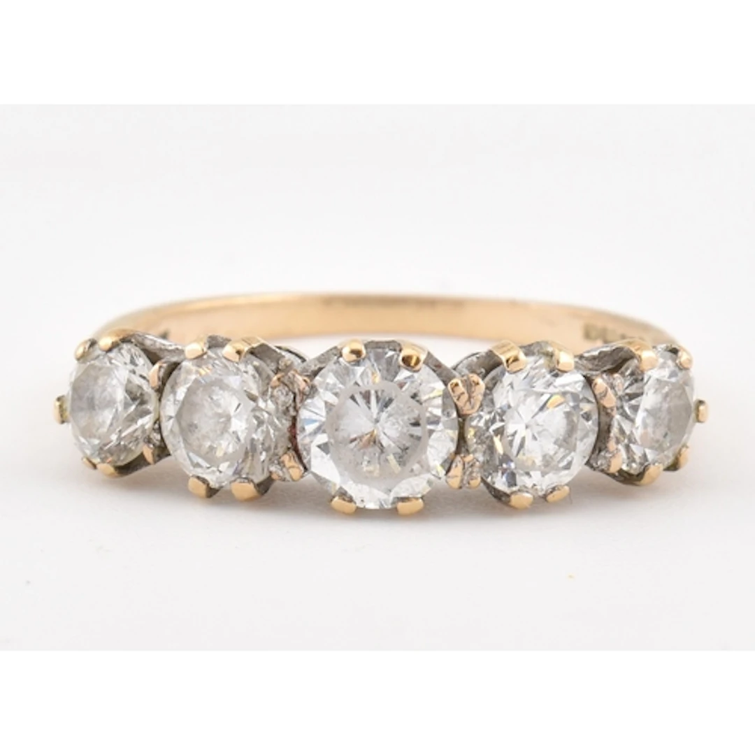A hallmarked 9ct gold and cubic zirconia five stone ring. Se...