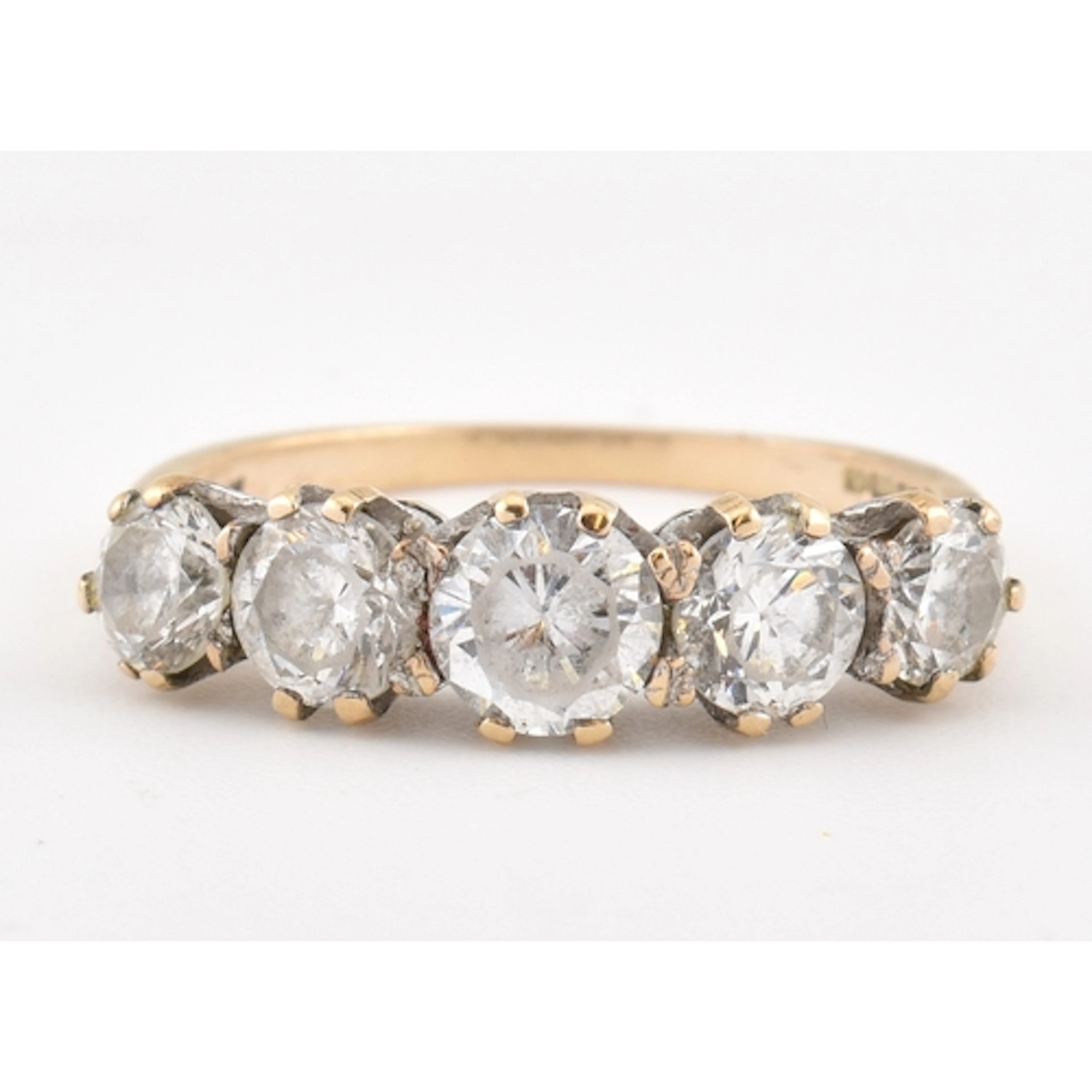 A hallmarked 9ct gold and cubic zirconia five stone ring. Se...