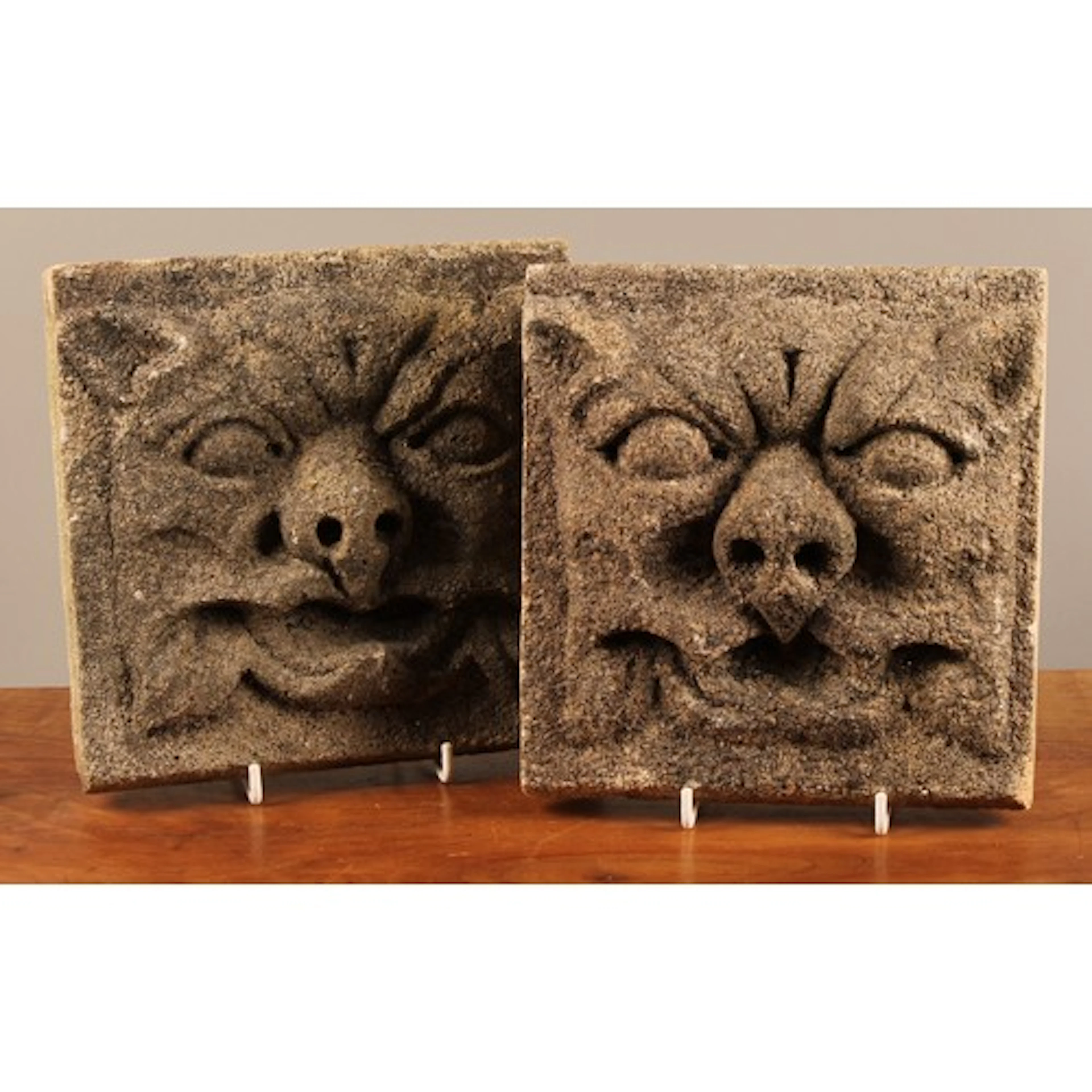 An associated pair of Medieval Revival gritstone plaques, ea...