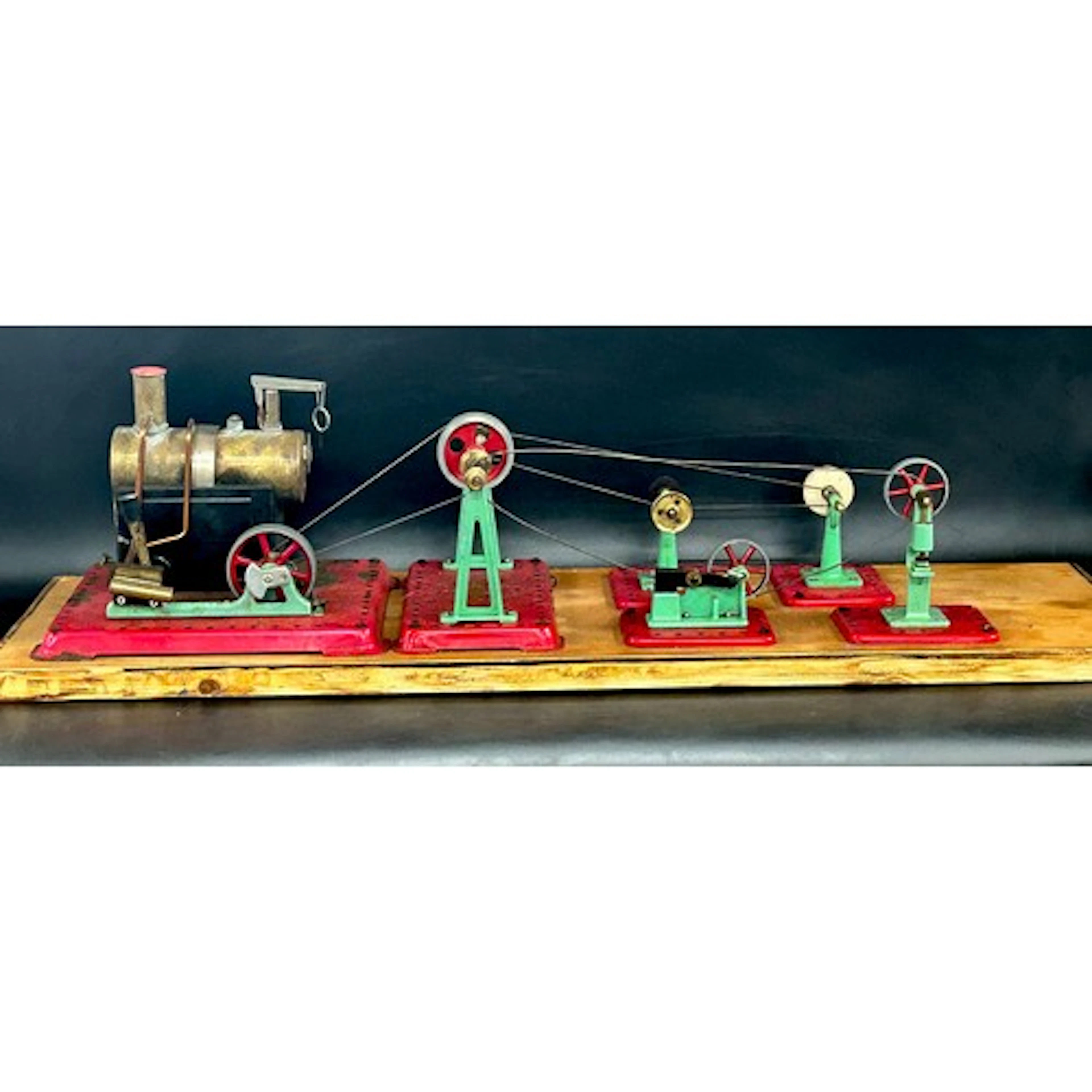 A Mamod live steam stationary engine mounted on wooden board