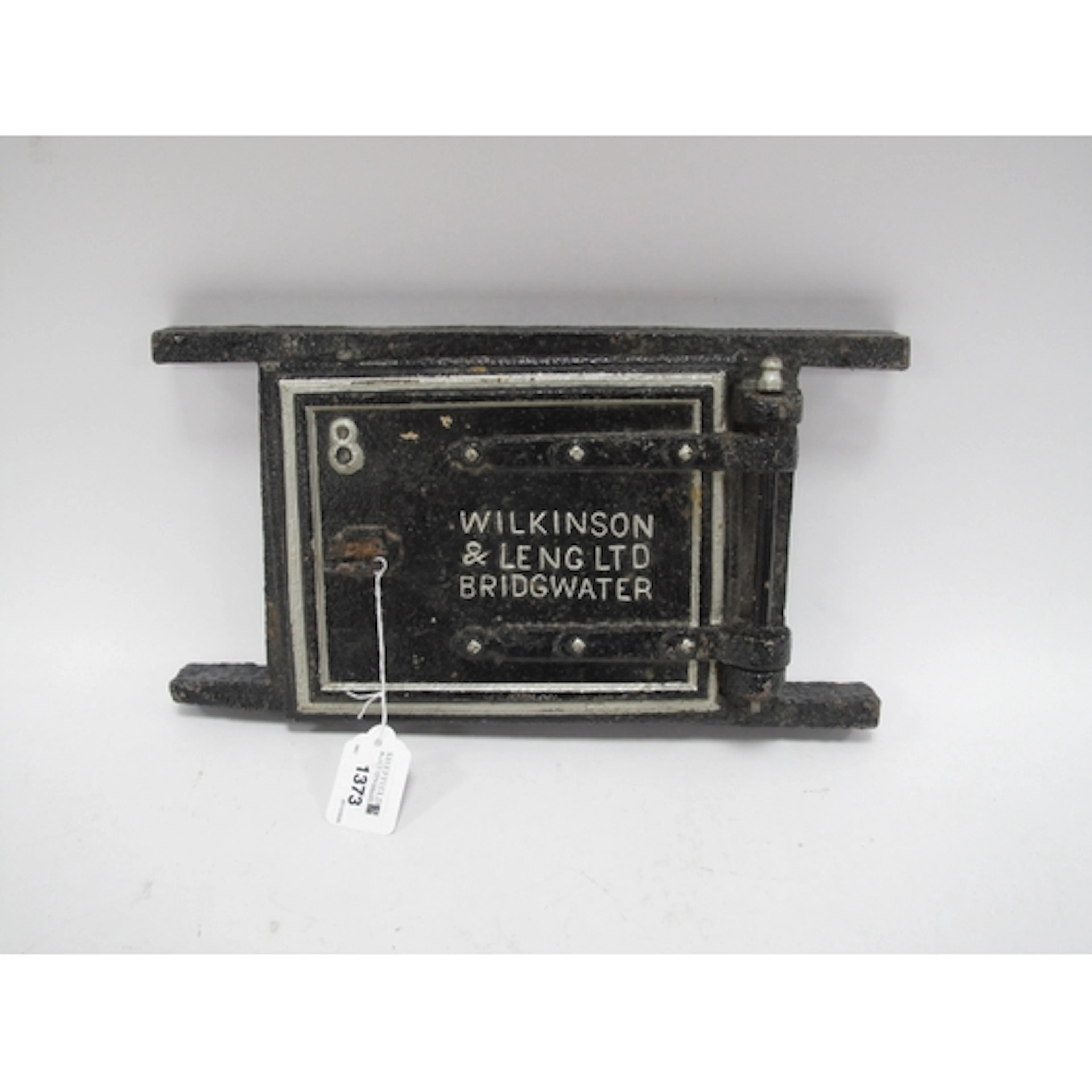 An Antique Cast-Iron Furnace Door Frame Manufactured by Wilk...