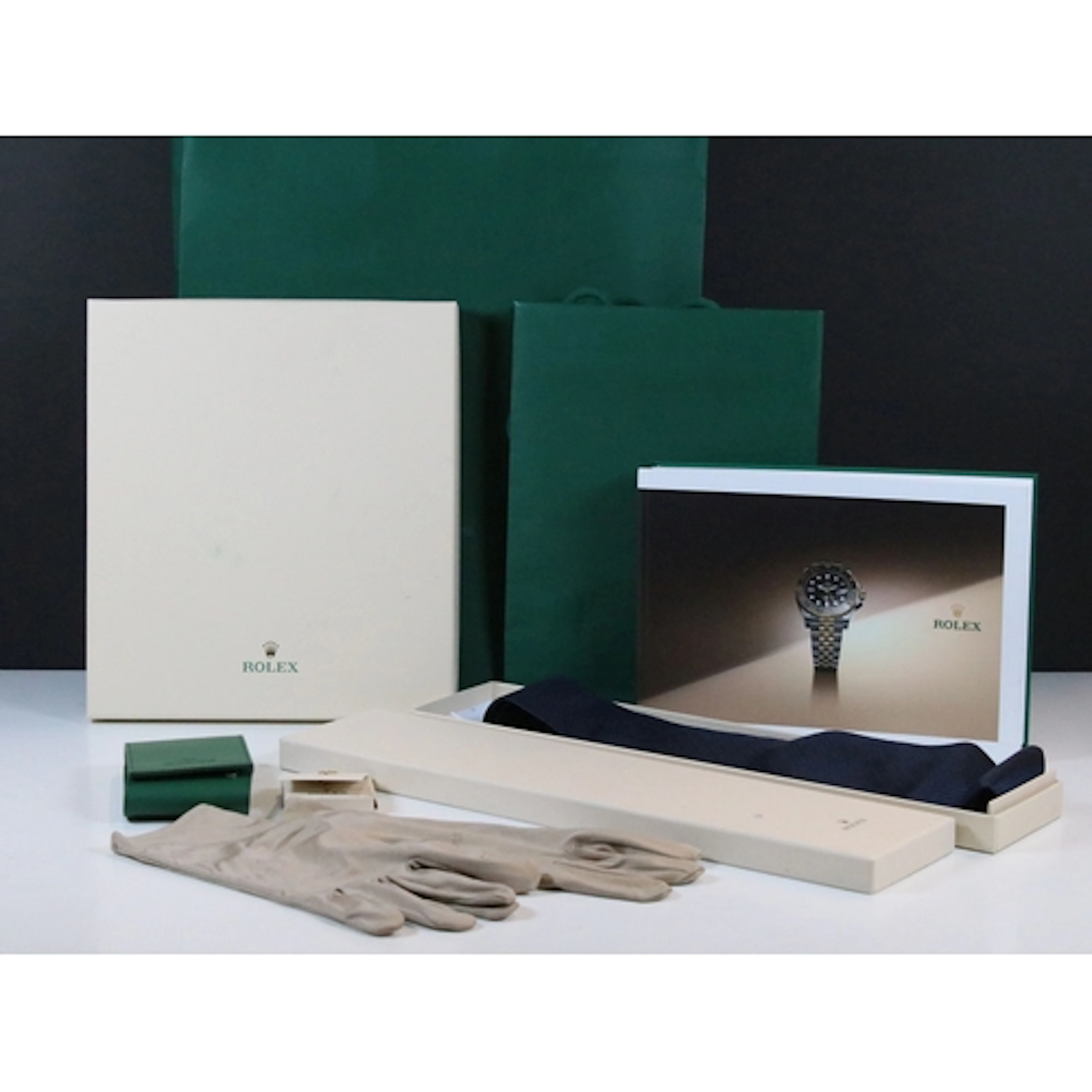 Collection of Rolex items to include a green leather wallet,...