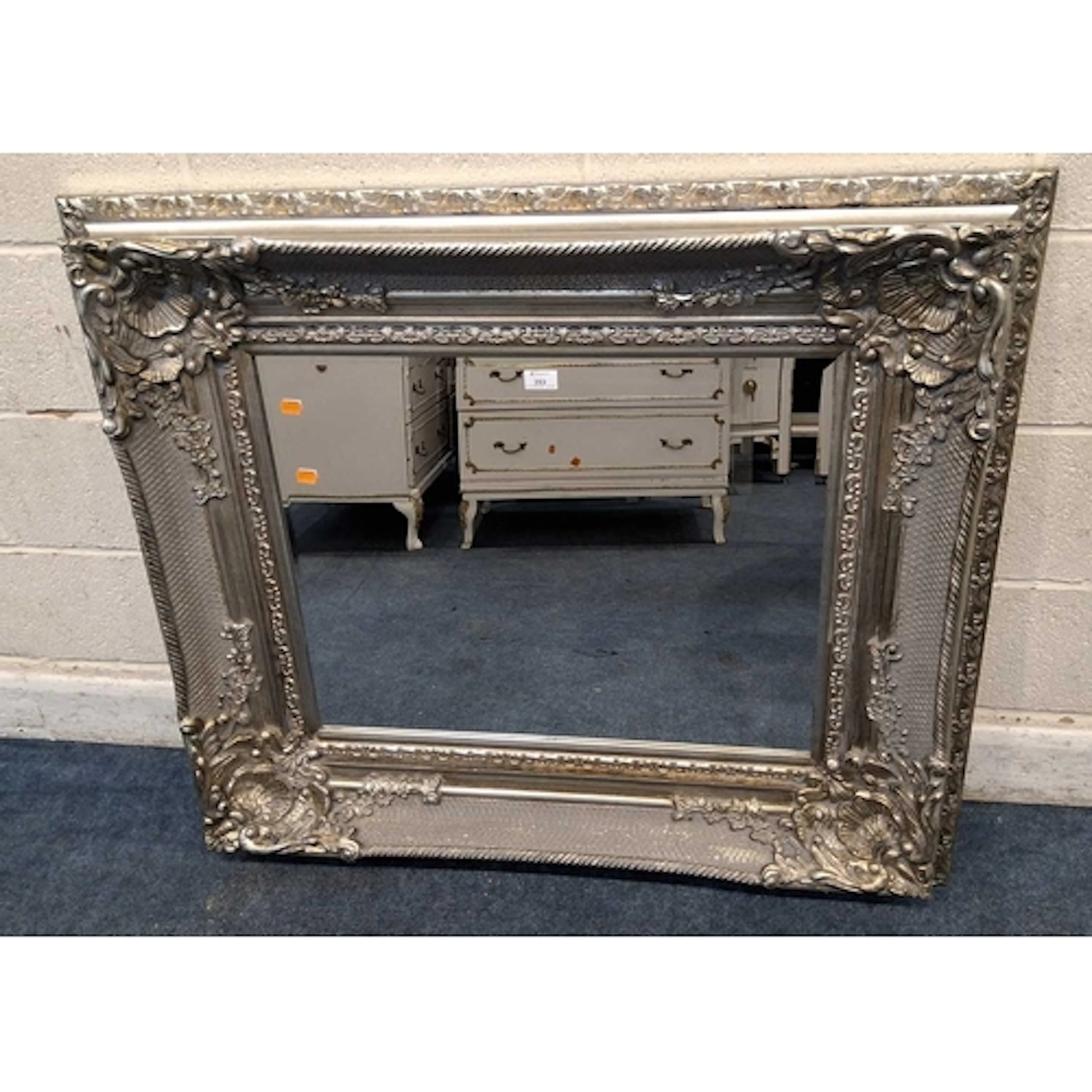 A RECTANGULAR DEEP FRAME SILVERED MIRROR, with shell, scroll...