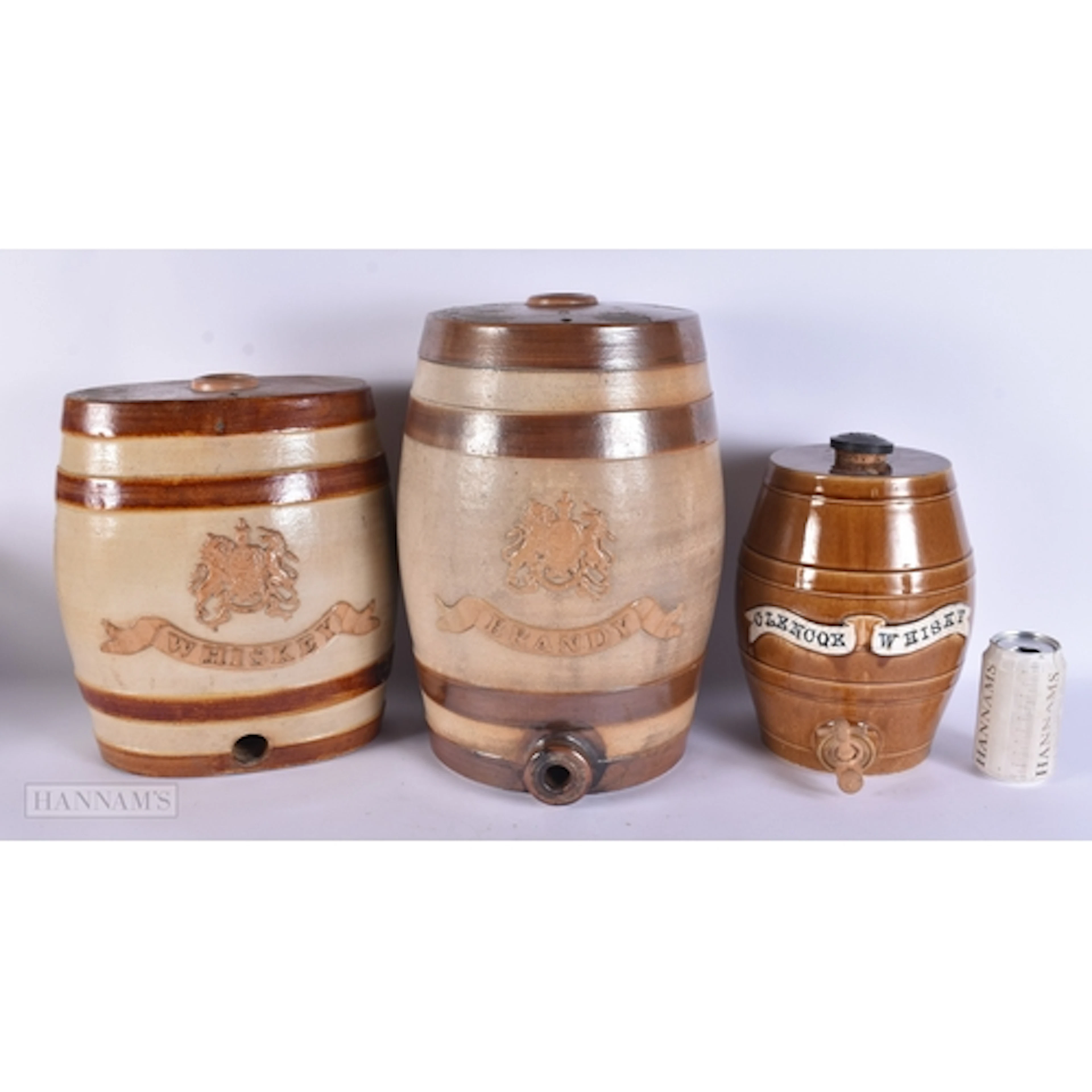 TWO LARGE ANTIQUE STONEWARE WHISKEY DECANTERS together with ...