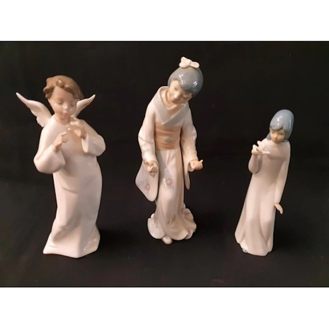 TWO NAO FIGURINES comprising an angel, 26cm high; and a Japa...