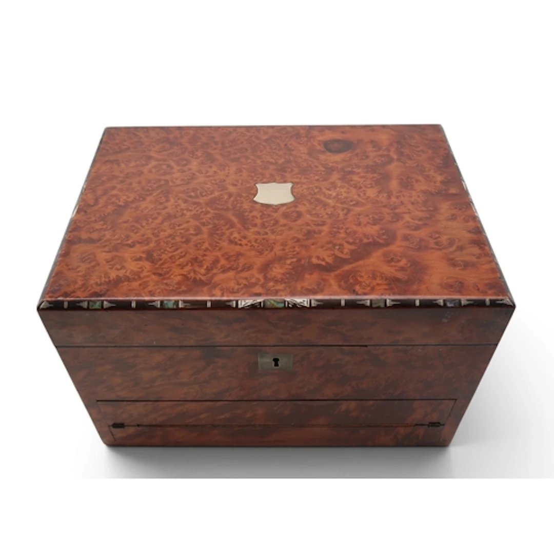 A burr wood jewellery/writing box with velvet lined compartm...