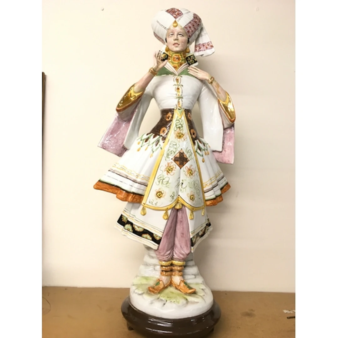 A large ceramic figure of an elaborately dressed Eastern fig...