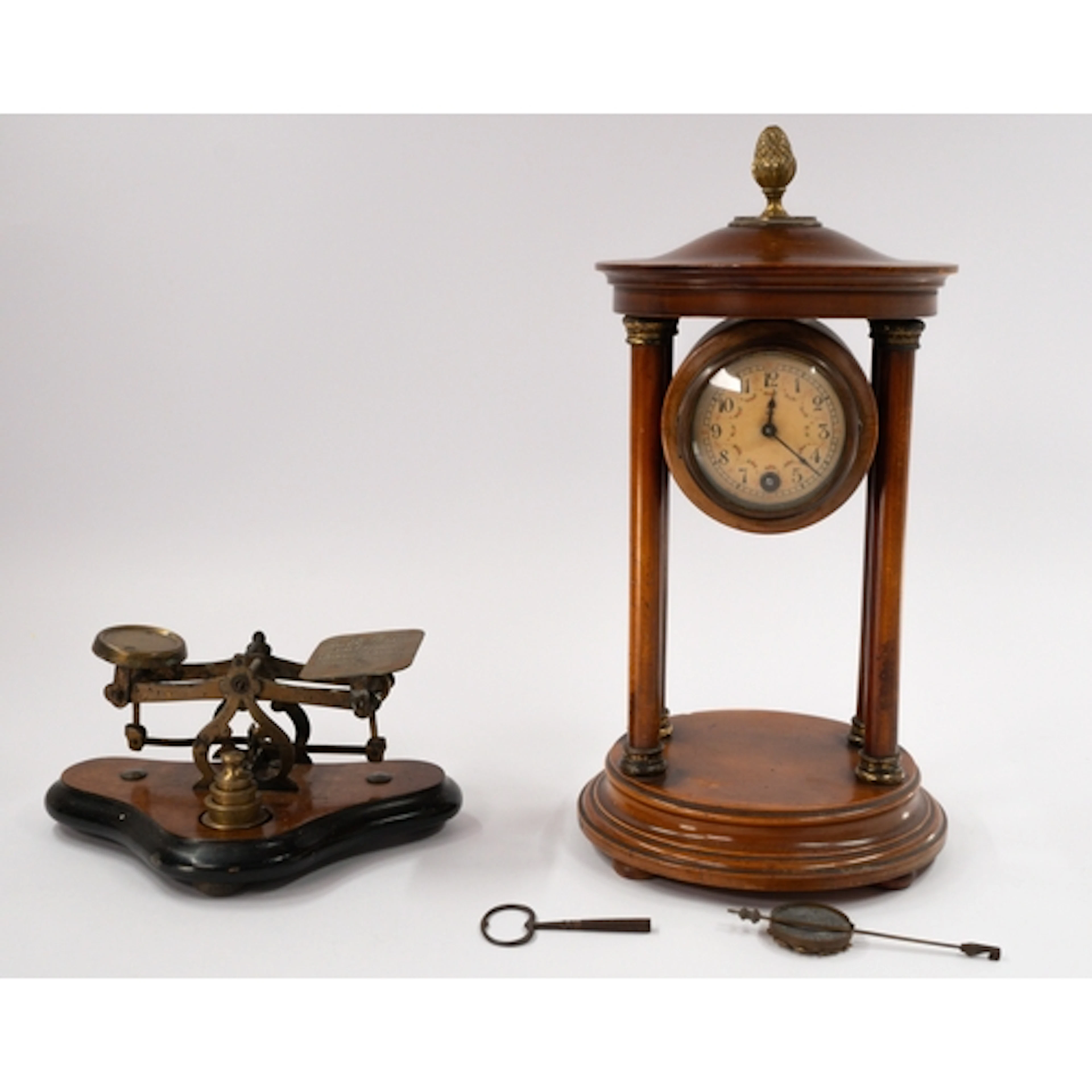 A portico mantel clock, late 19th century, the flowered dial...