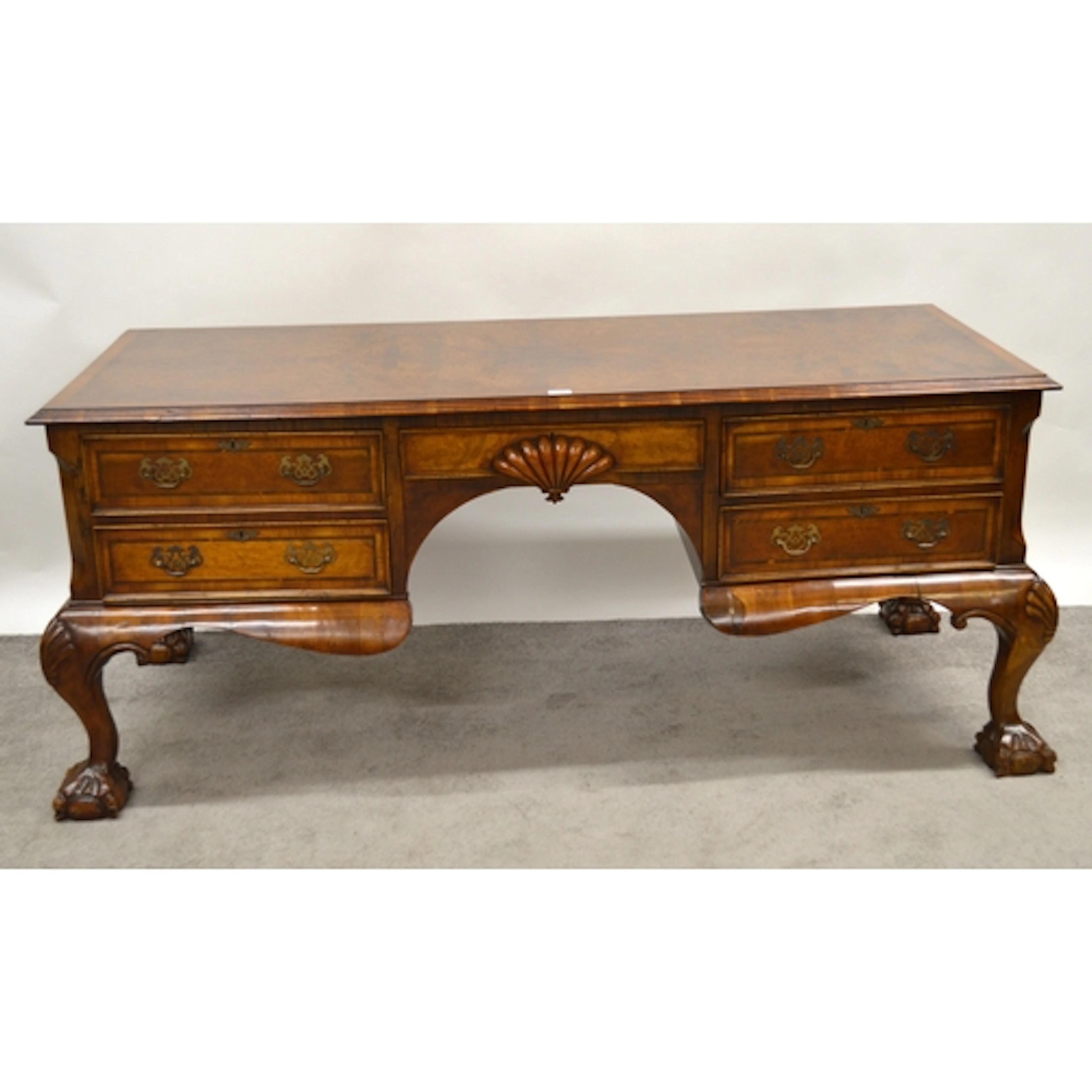Continental walnut kneehole partner's desk, the moulded top ...