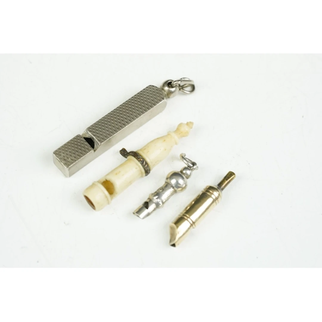 Group of four miniature whistles, comprising: carved bone, 3...