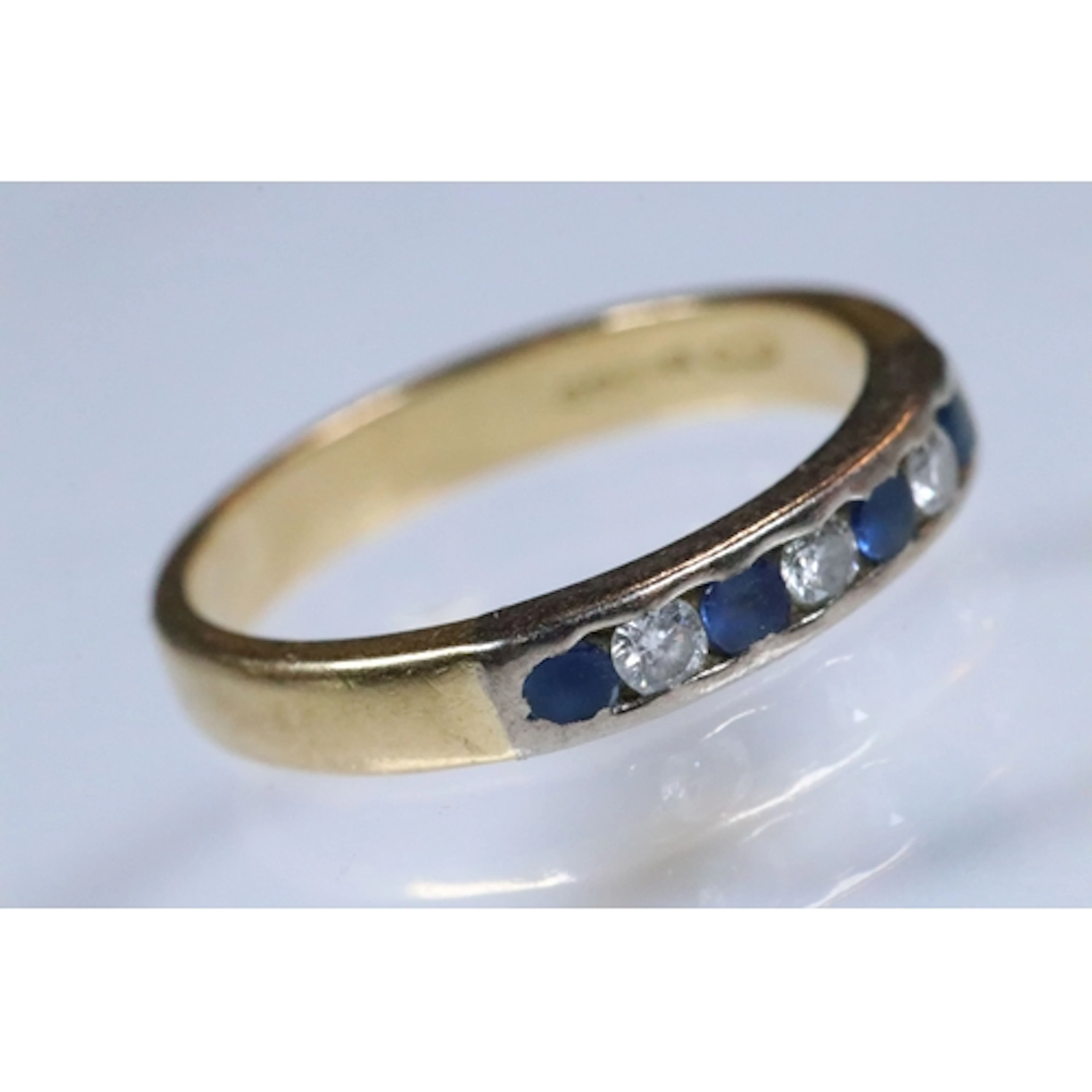 18ct gold, diamond and sapphire seven stone ring. The ring b...