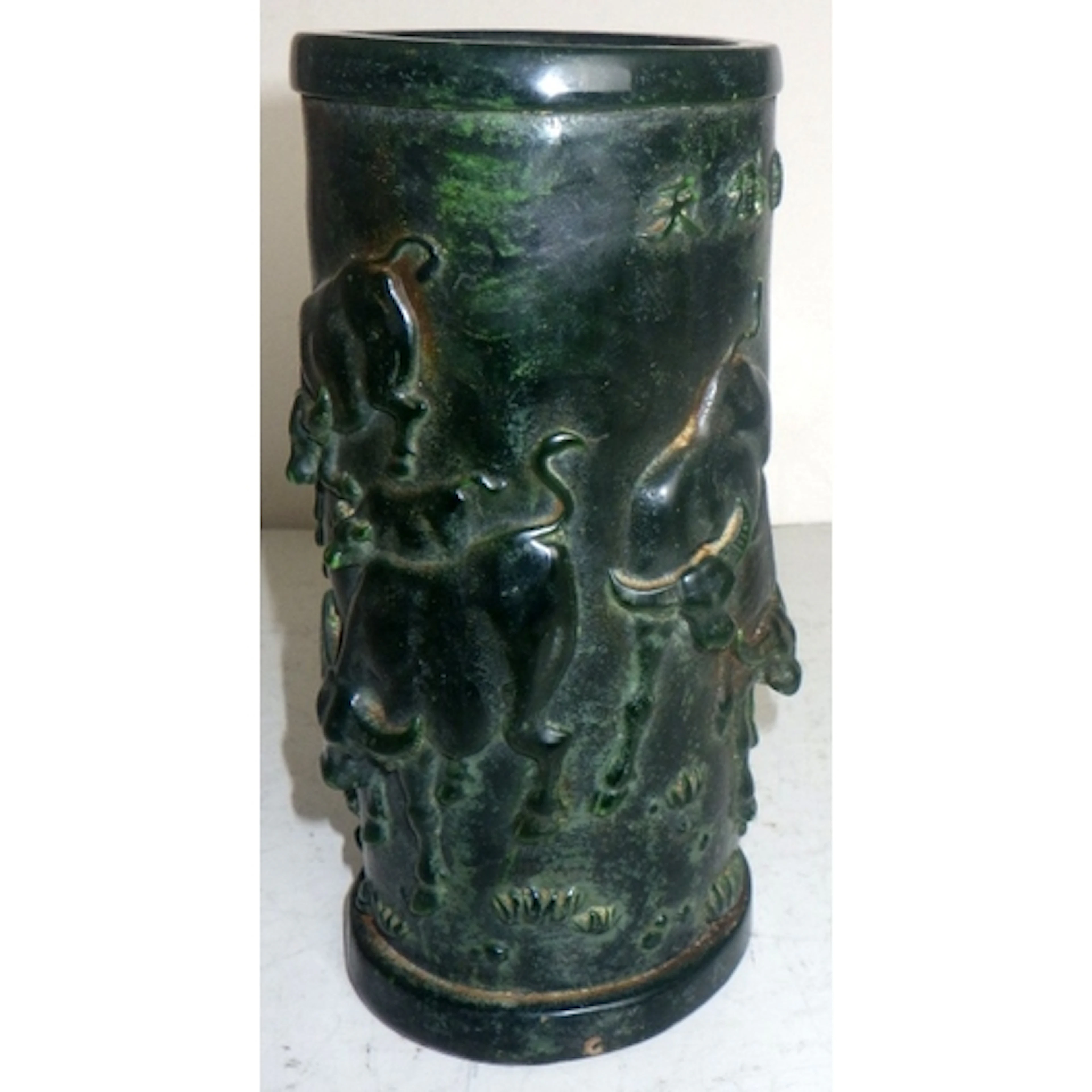 A carved hard stone cylindrical vase decorated with bison