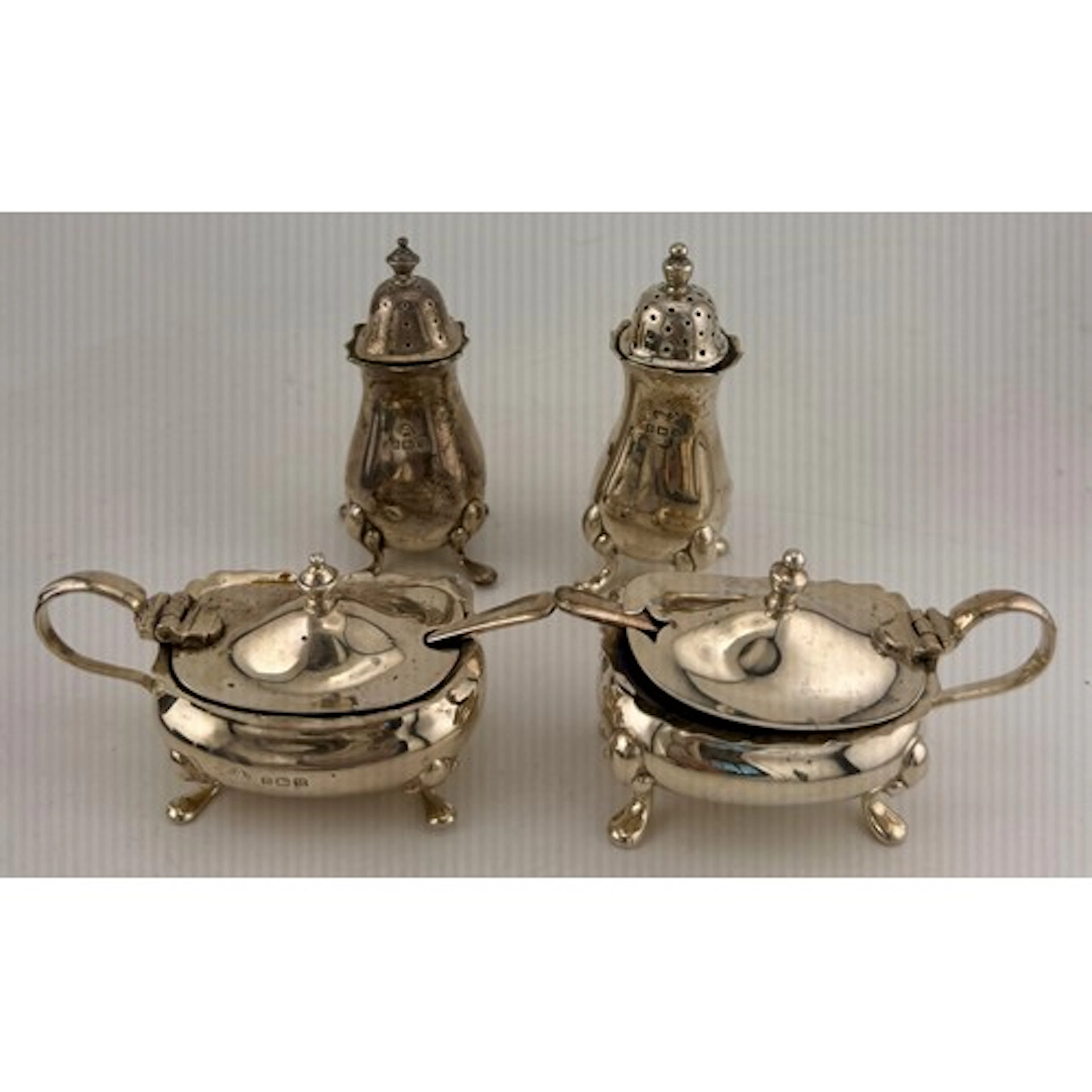 Hallmarked silver cruet comprising two pepper pots, two must...