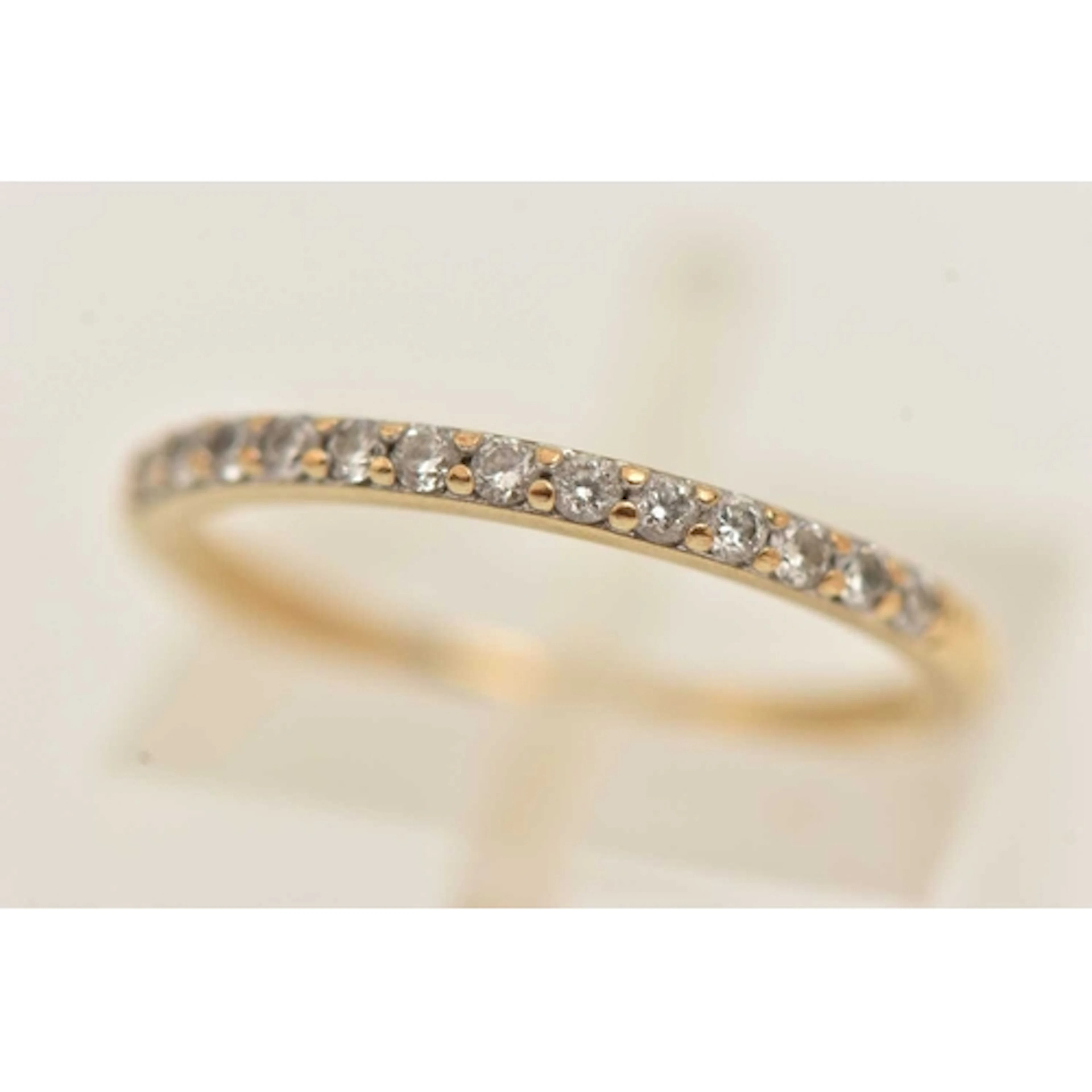 A 9CT GOLD DIAMOND HALF ETERNITY RING, set with a row of sma...
