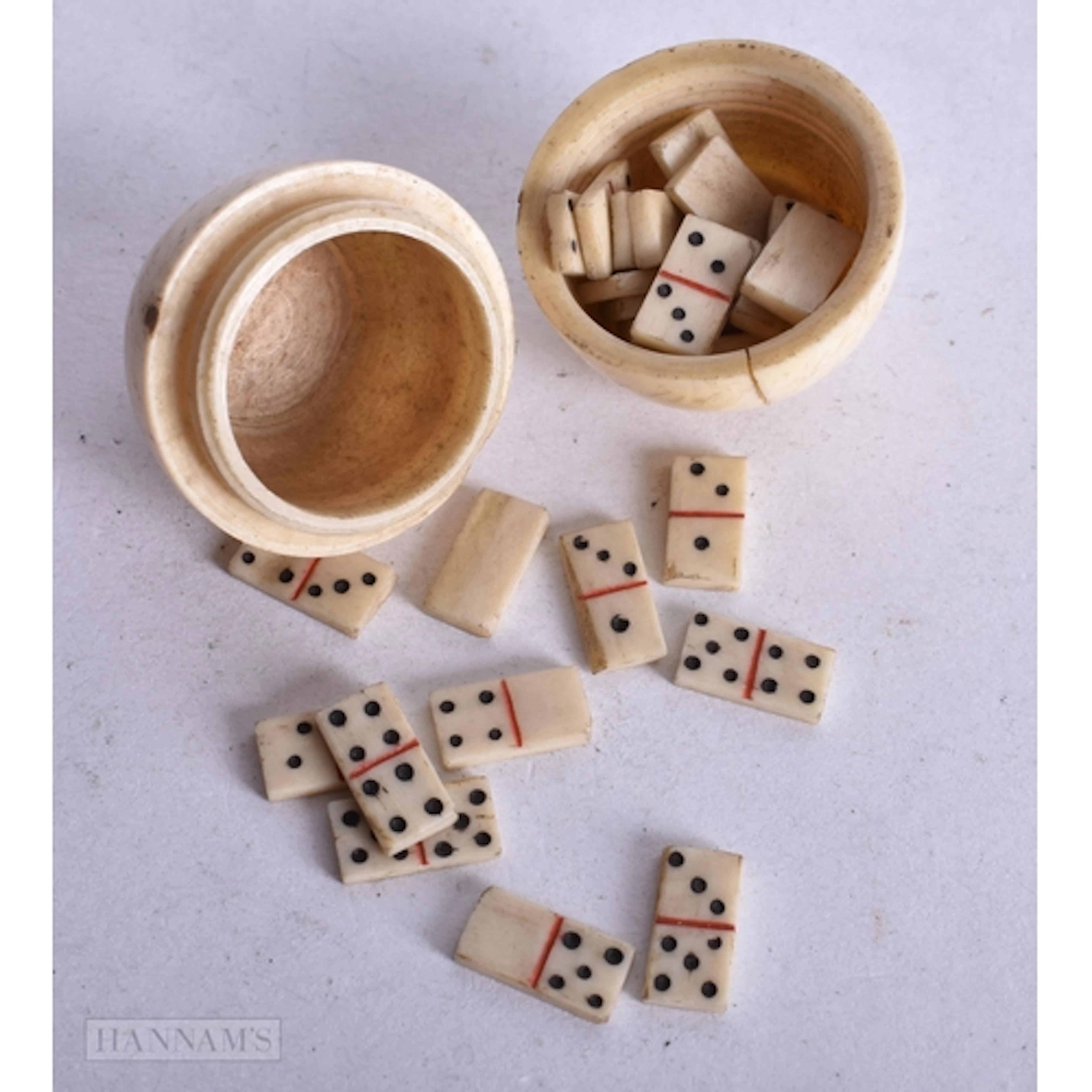 AN ANTIQUE BONE EGG FORM BOX containing gaming counters. 3.5...