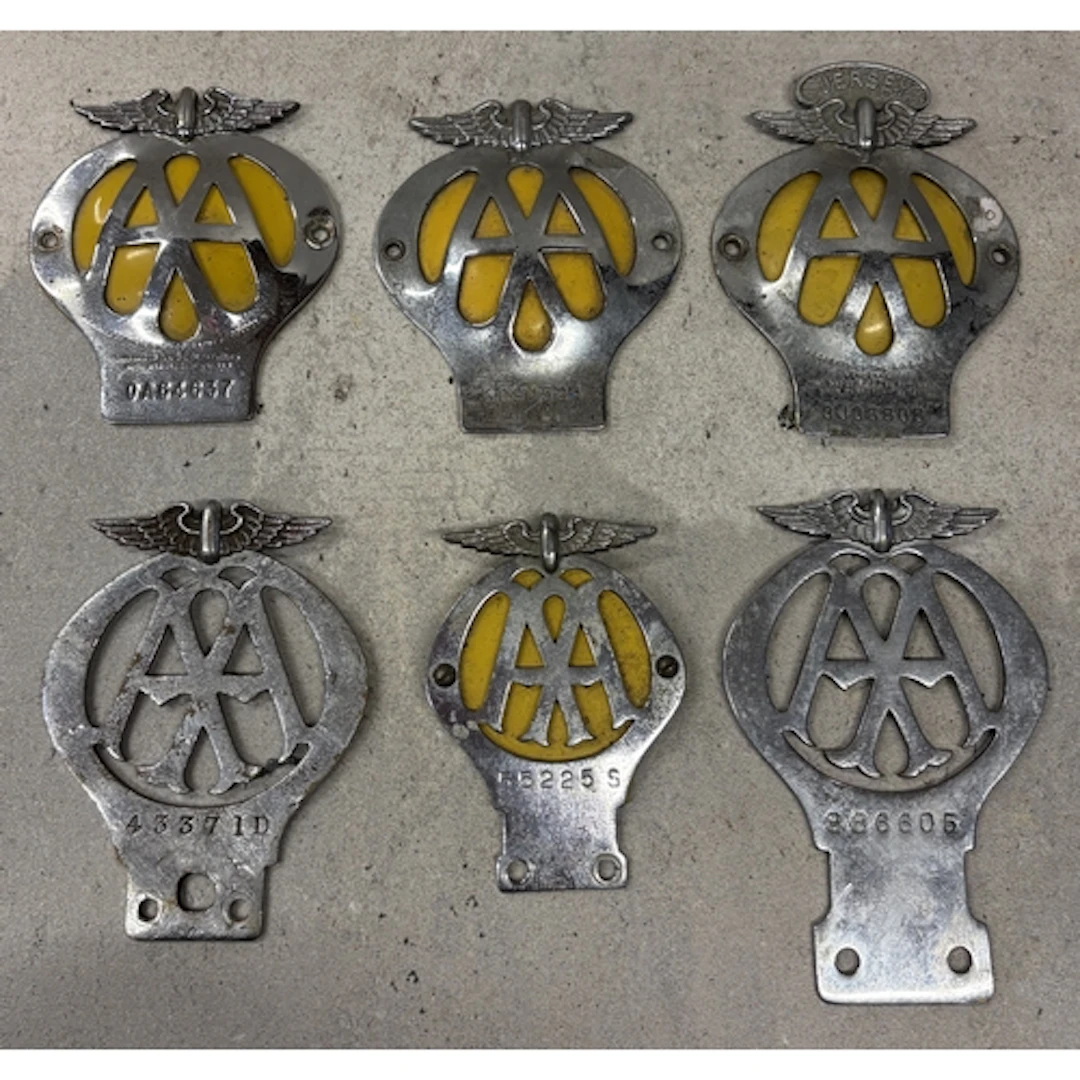 A collection of six vintage AA badges to include a motorcycl...