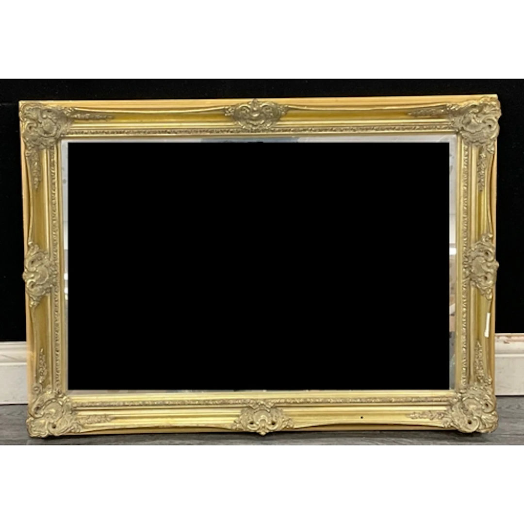 A rococo revival style gilt framed mirror with acanthus scro...