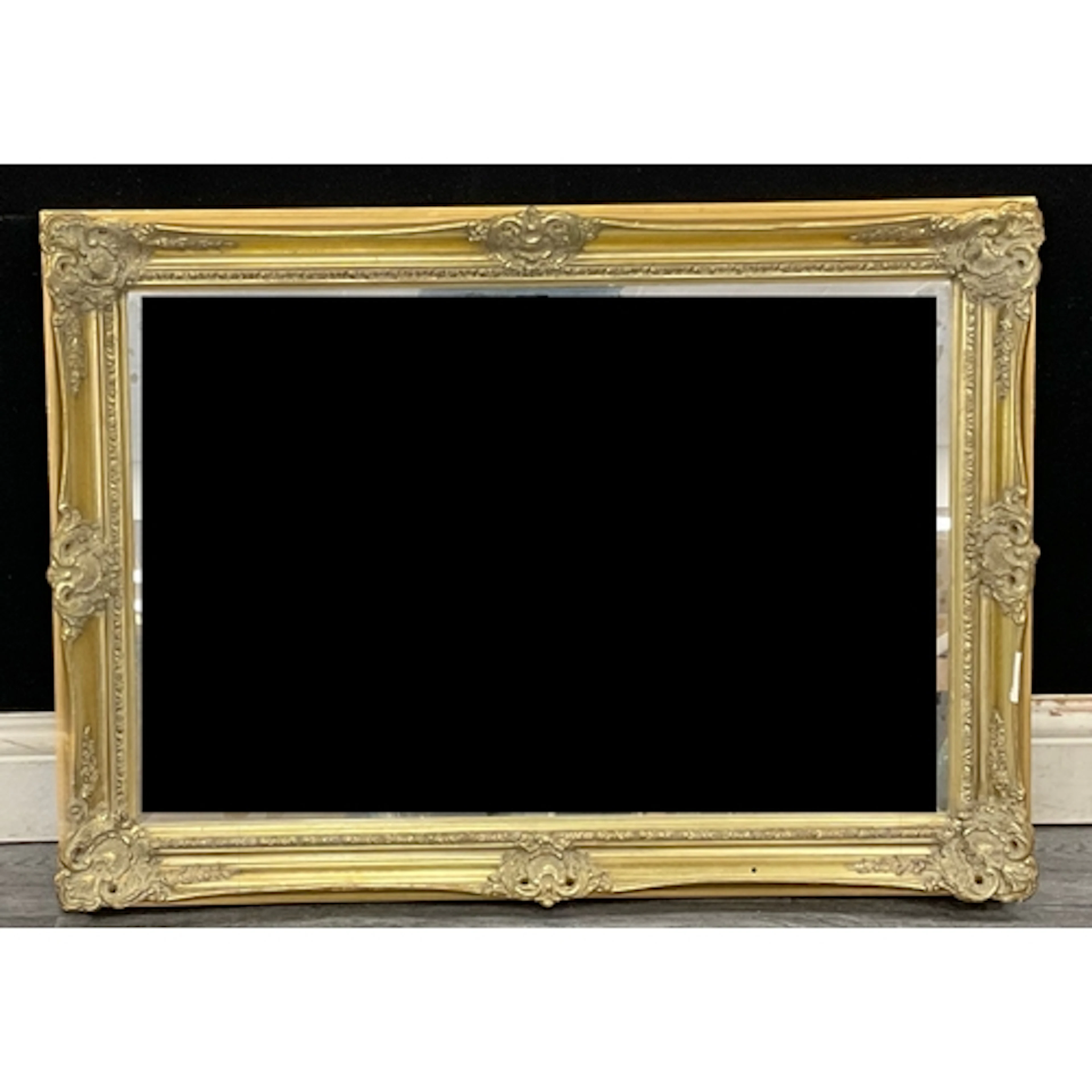 A rococo revival style gilt framed mirror with acanthus scro...