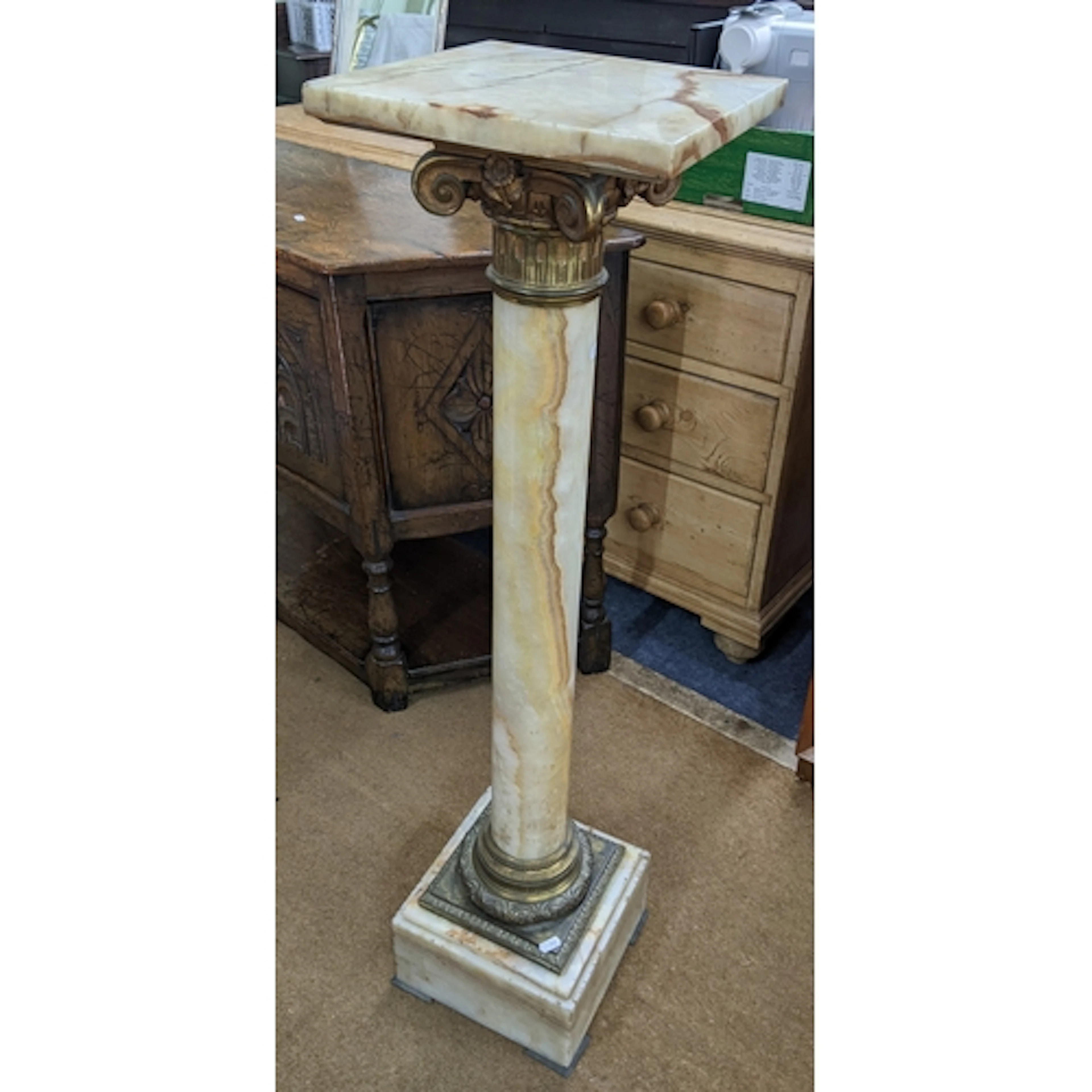 An onyx and gilt metal Corinthian column pedestal, having a ...