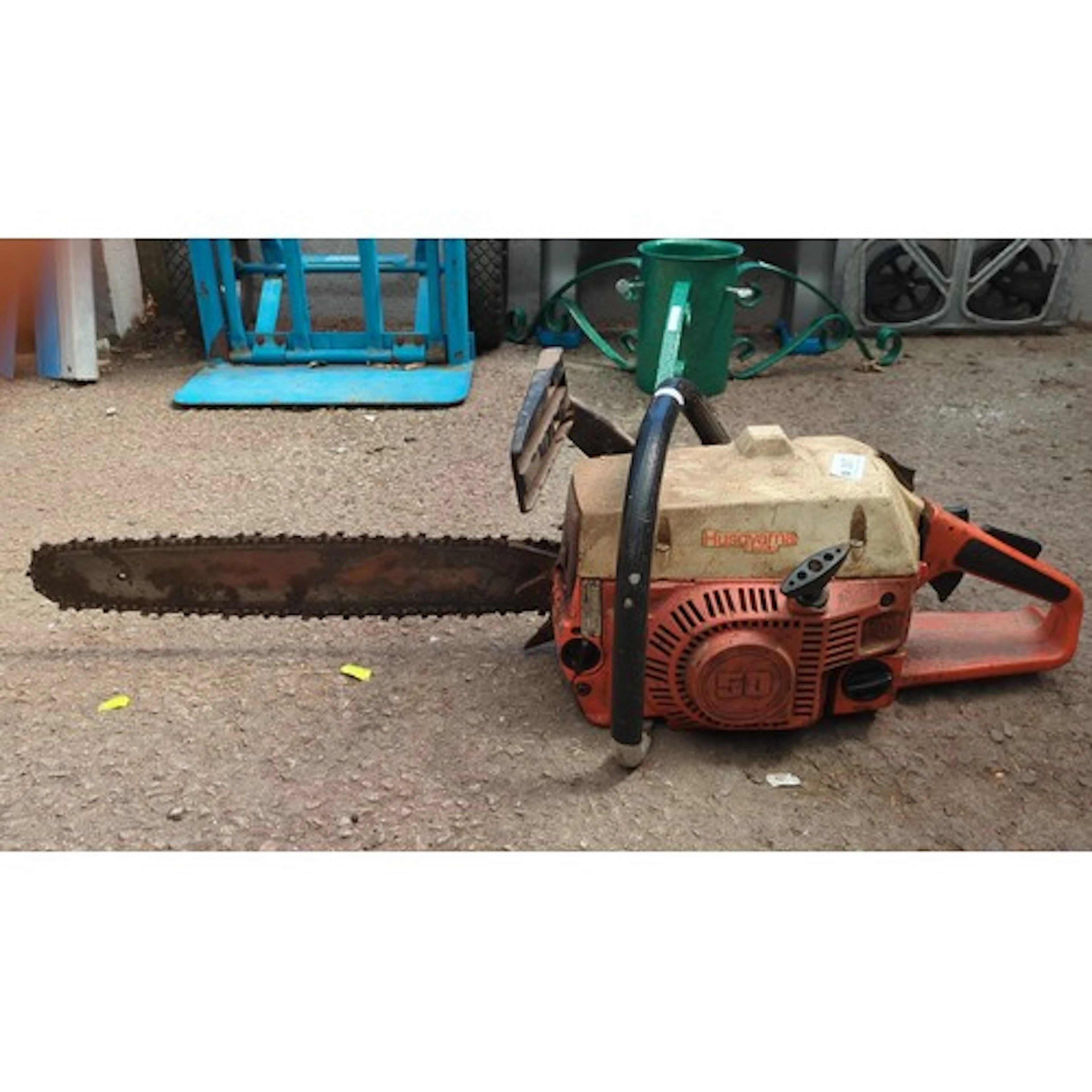 Husqvarna petrol chainsaw with orange and cream casing, fitt...