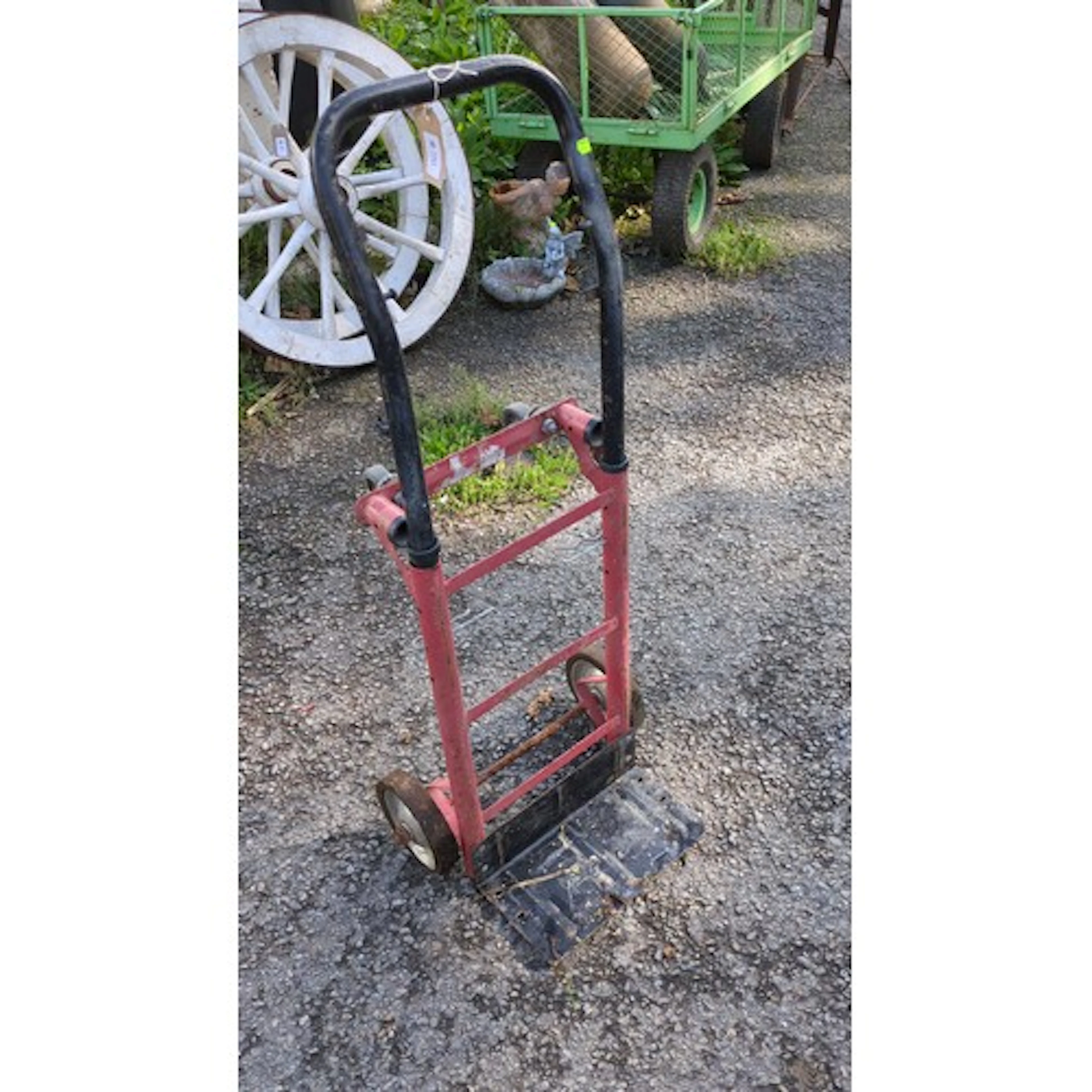 Industrial steel hand truck, the red tubular frame with blac...