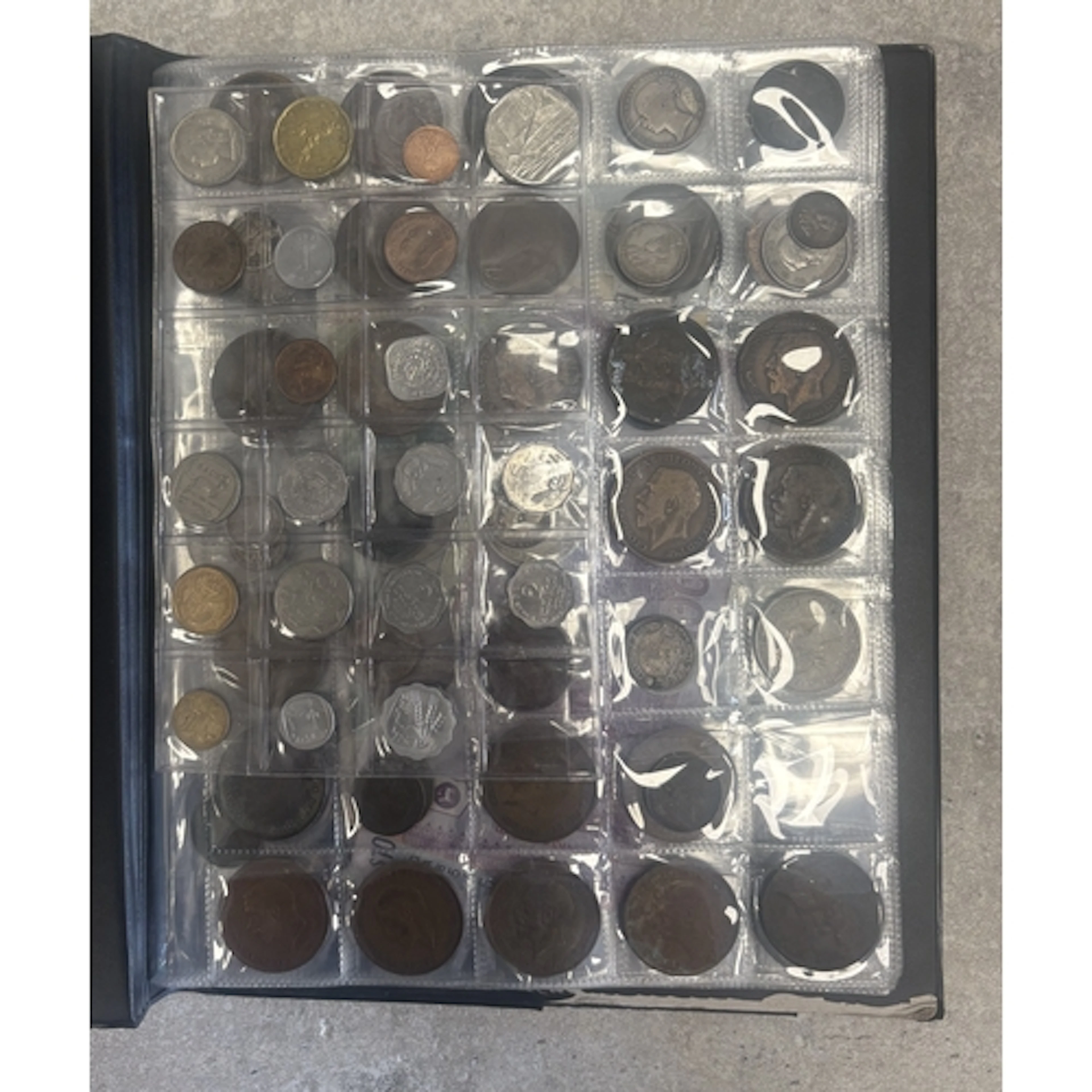 A folder containing old coins and paper money. Est. £20 - £3...