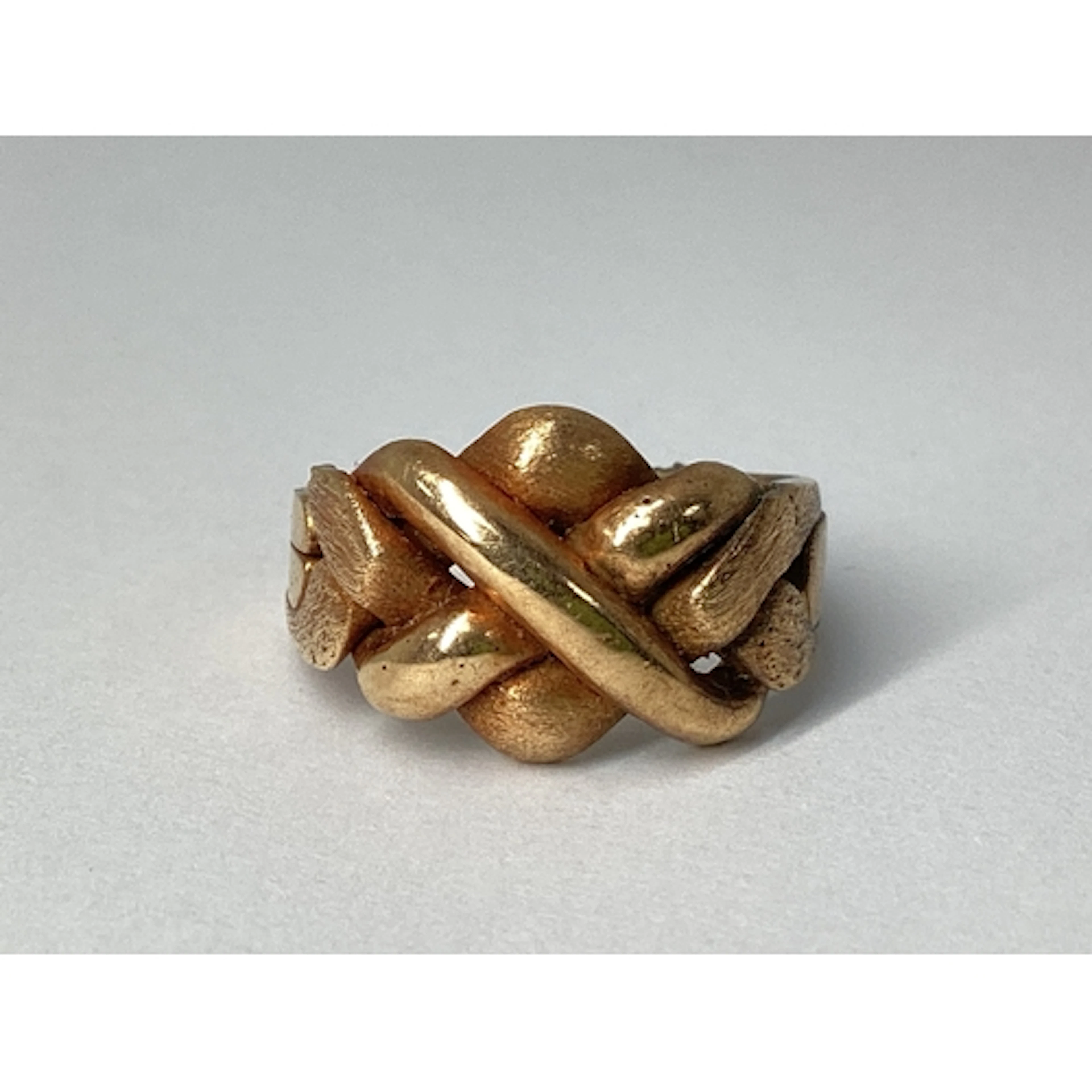 A Four Piece Puzzle Ring, (damage/loss), (finger size K1/2).