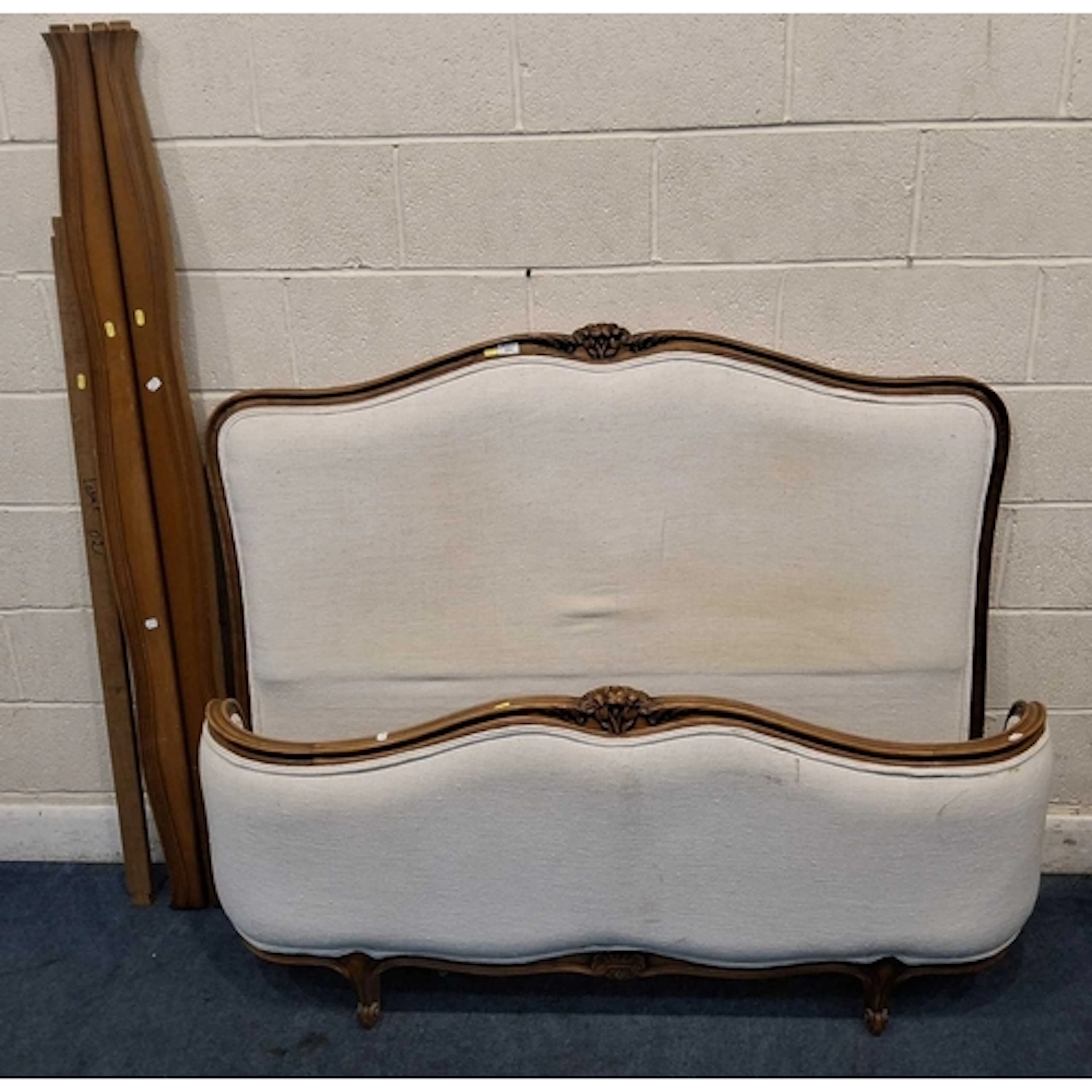 A FRENCH 4FT6 BEDSTEAD, with beige fabric, siderails, slats ...