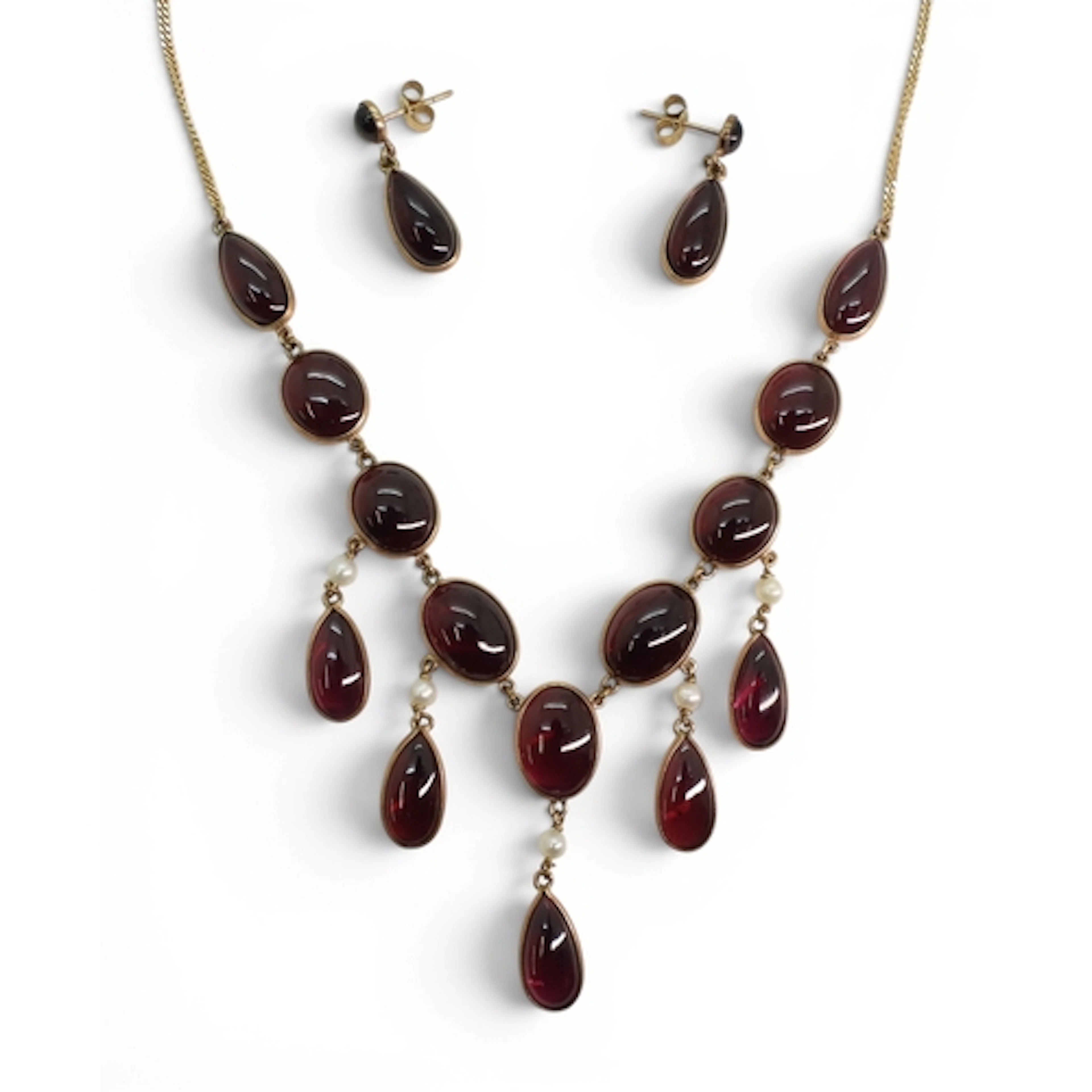 A SUITE OF GARNET JEWELS a festoon style necklace, the oval ...