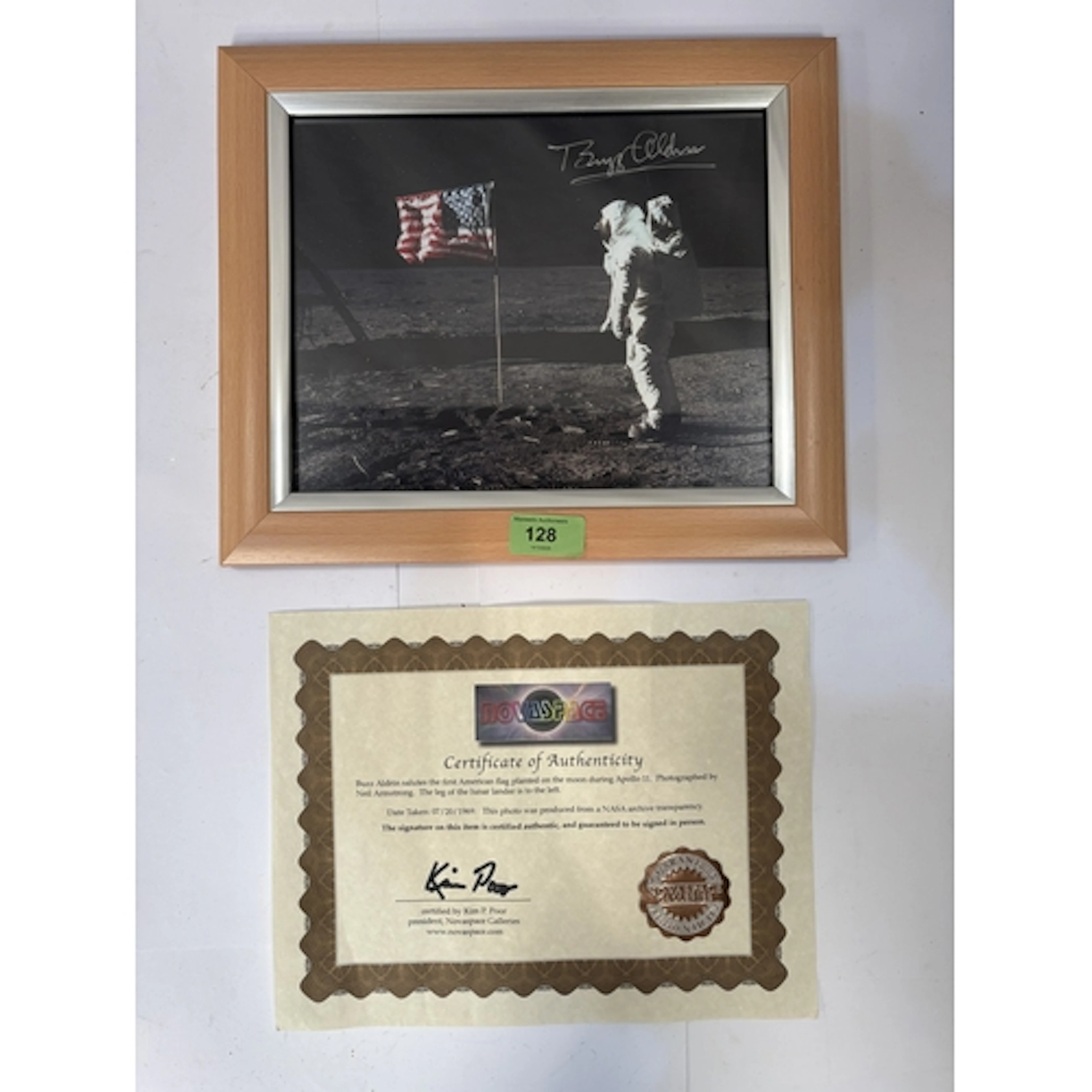 A signed photo by Buzz Aldrin of him walking on the moon, wi...