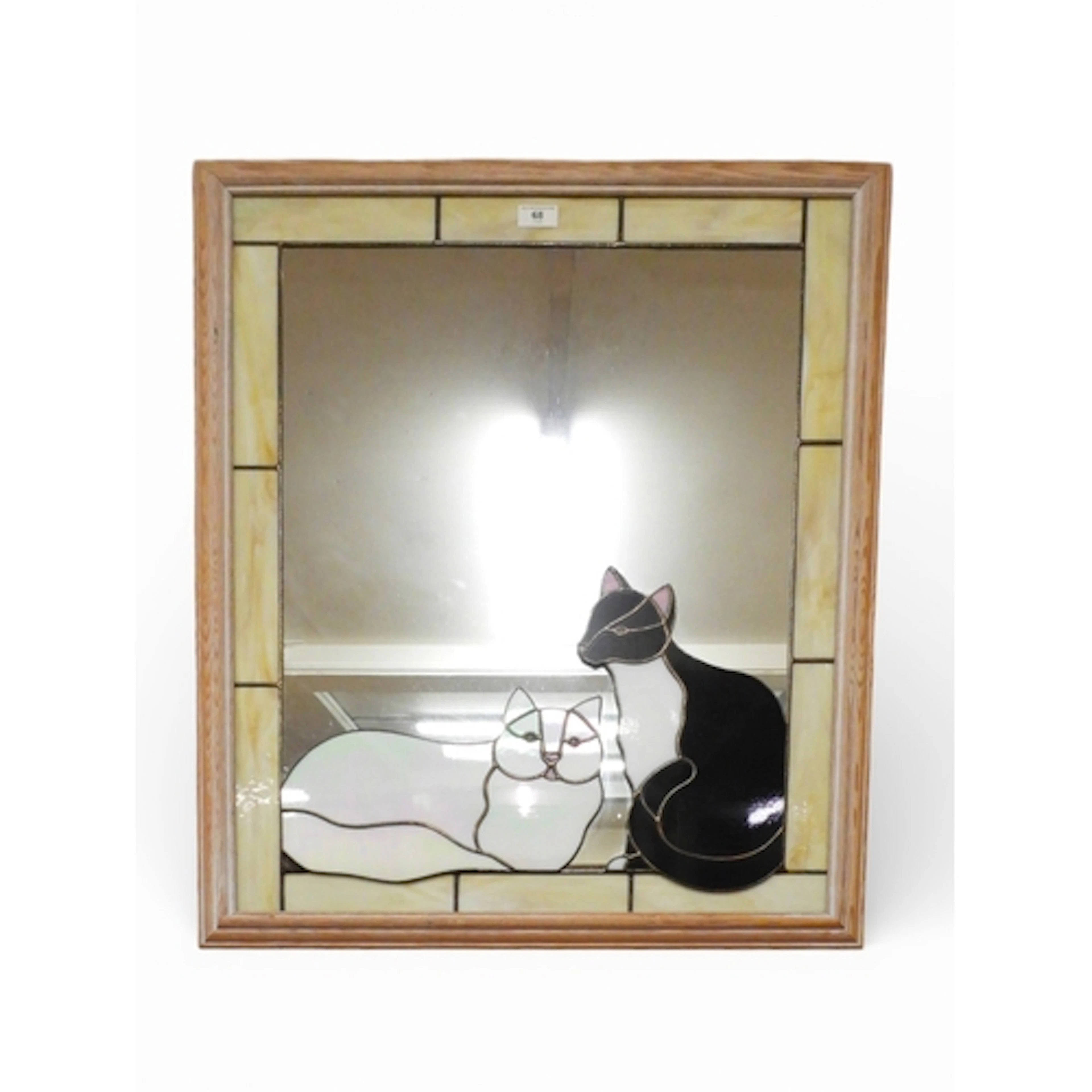 A 20th century limed frame wall mirror with decorative leade...