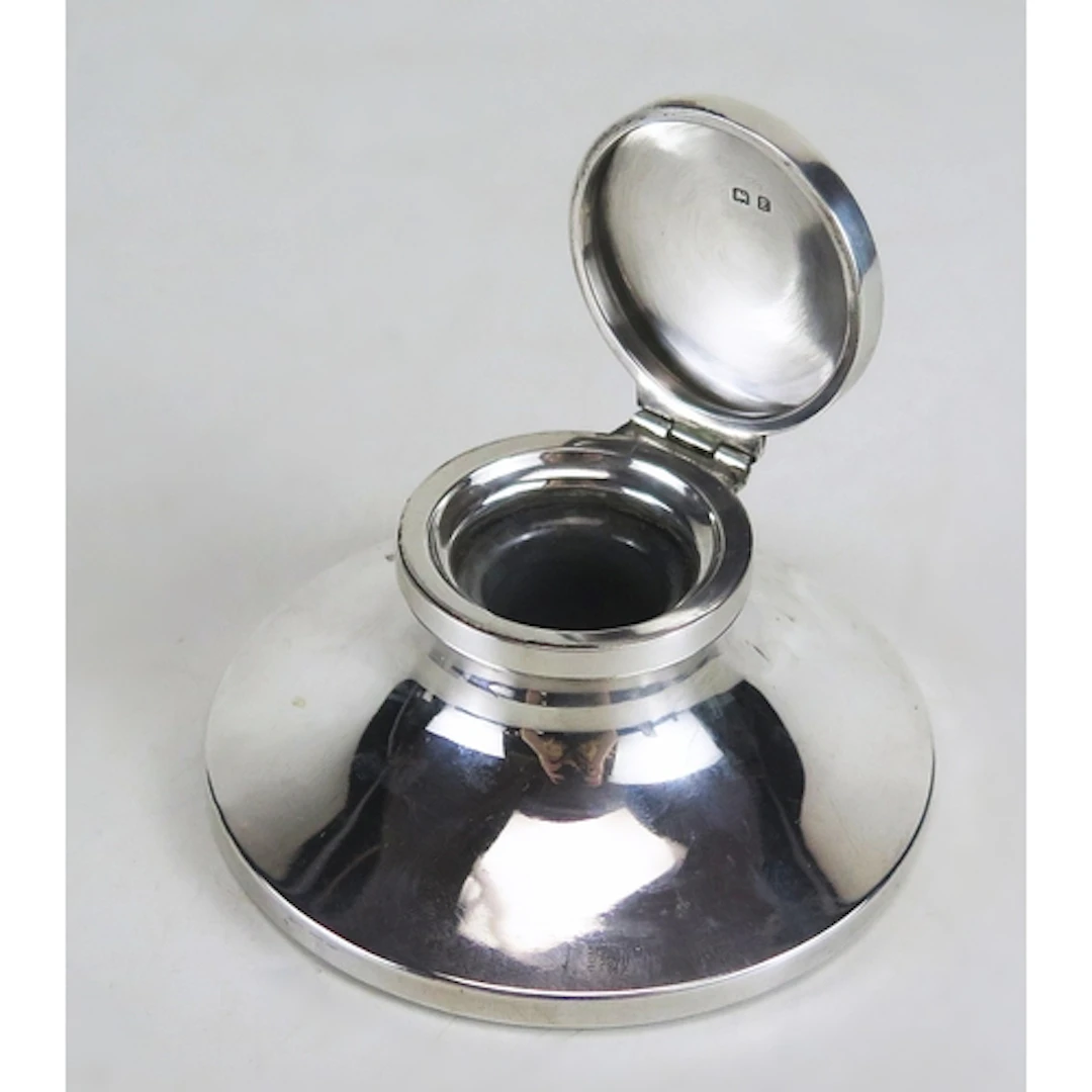 A George V silver capstan inkwell, maker William Neale & Son...