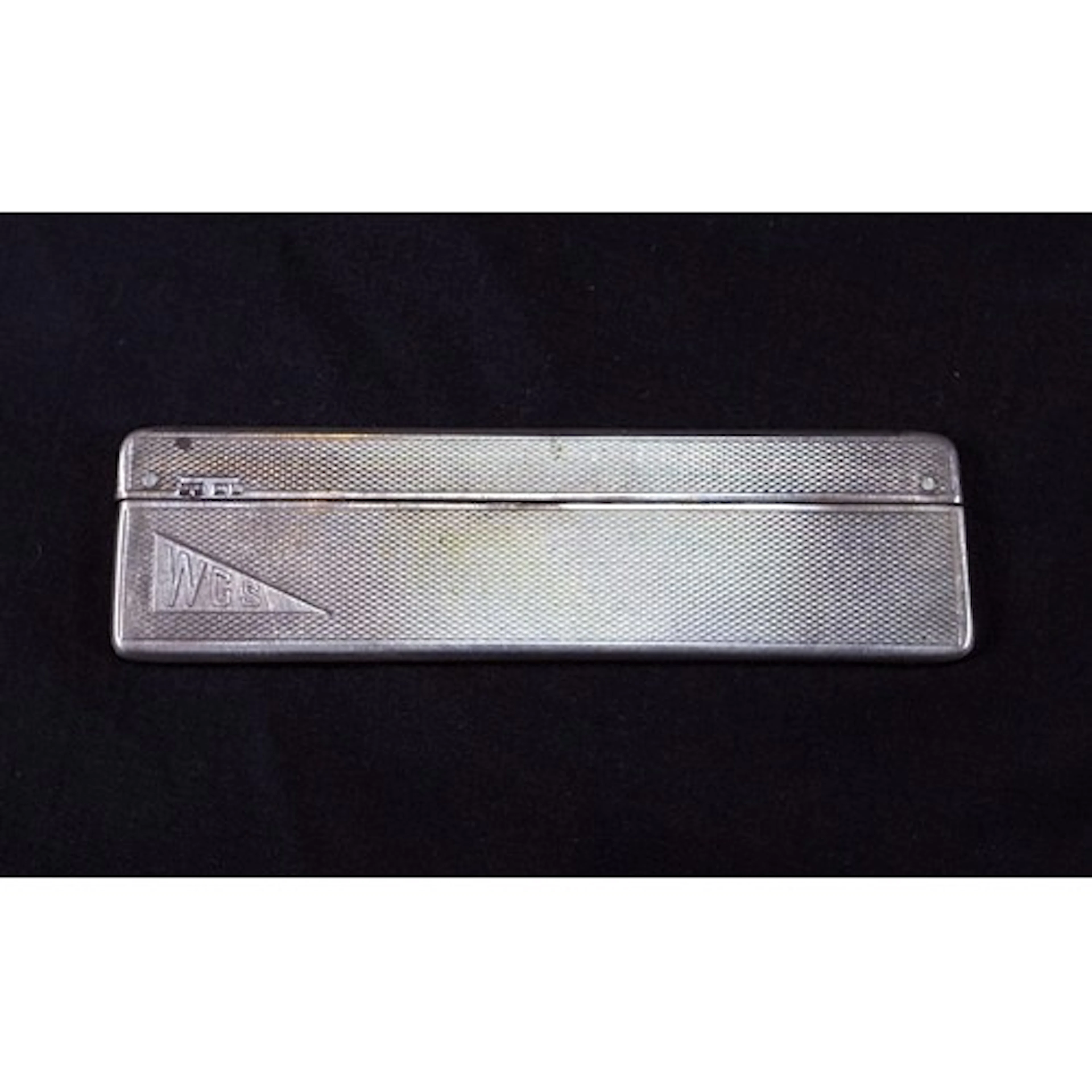 A hall marked silver Art Deco cased comb engine turned, weig...