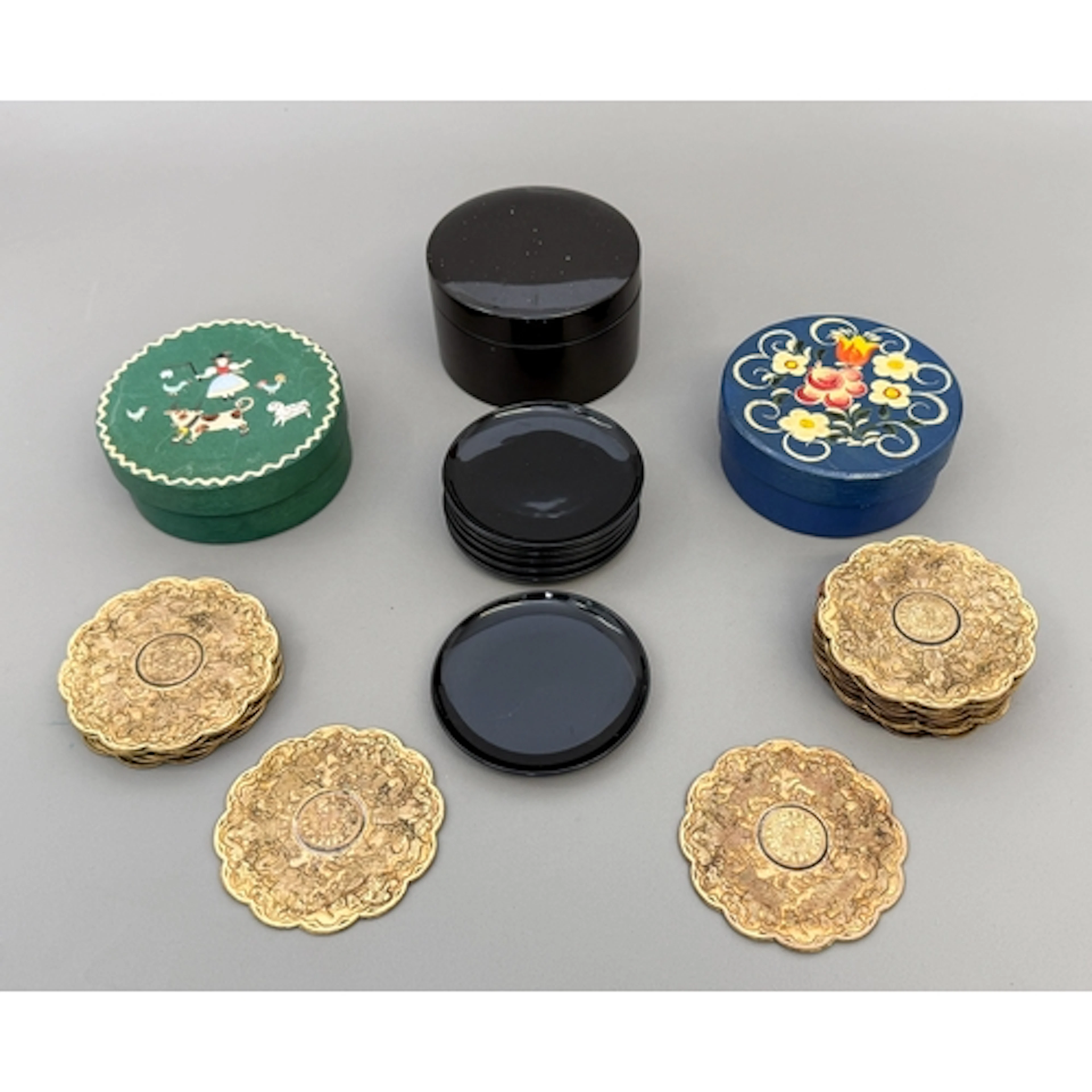 Three sets of vintage drinks coasters - comprising two match...