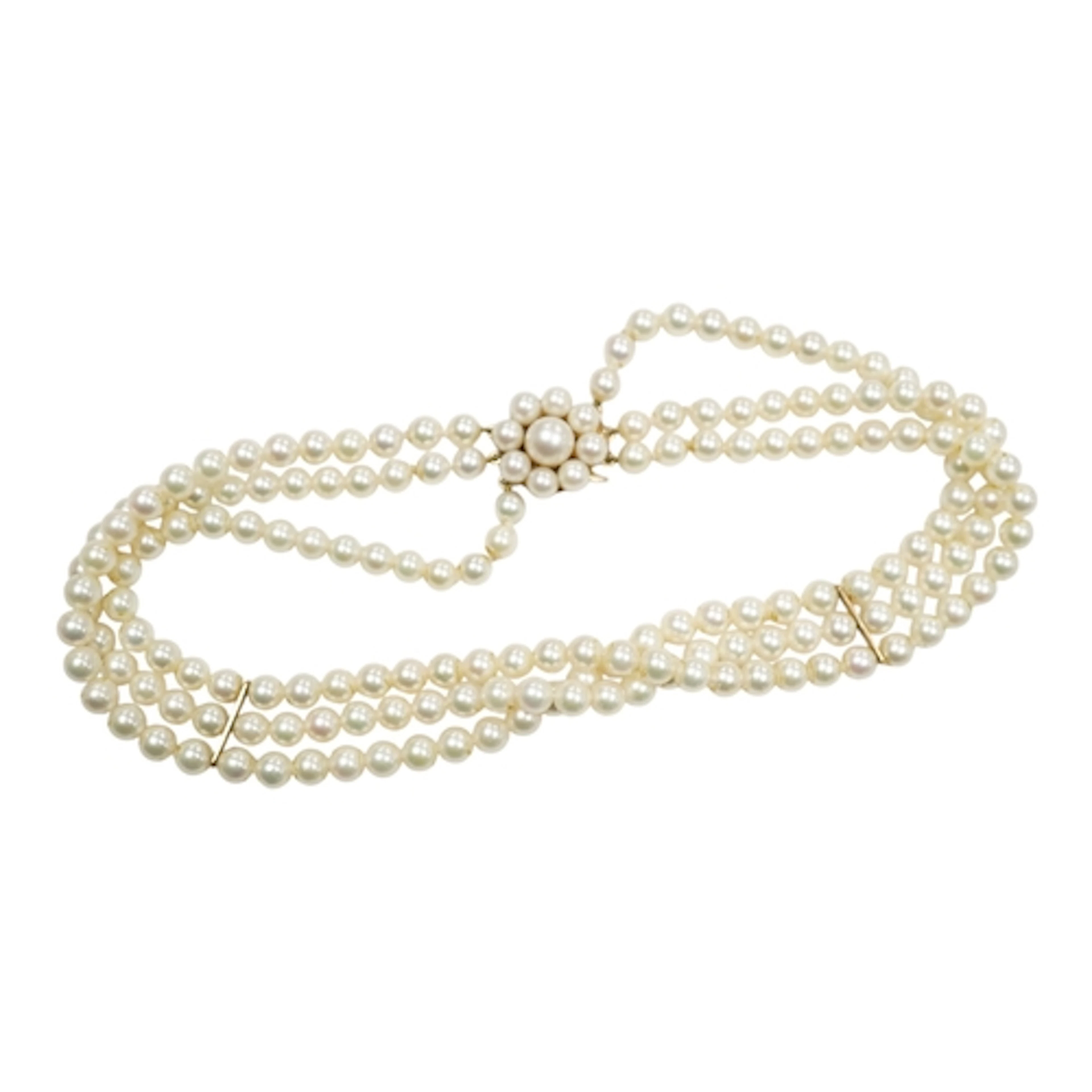 A late 20th century triple strand cultured pearl choker neck...