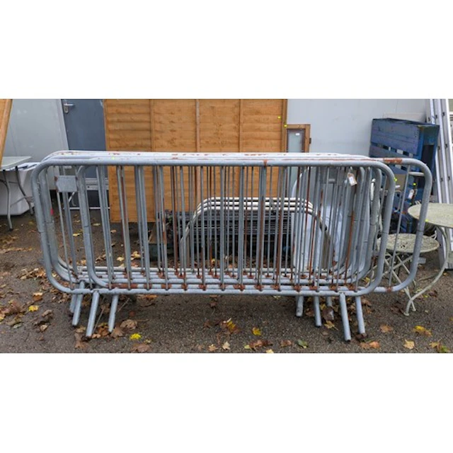A group of 6 x steel crowd-control barriers with rounded tub...